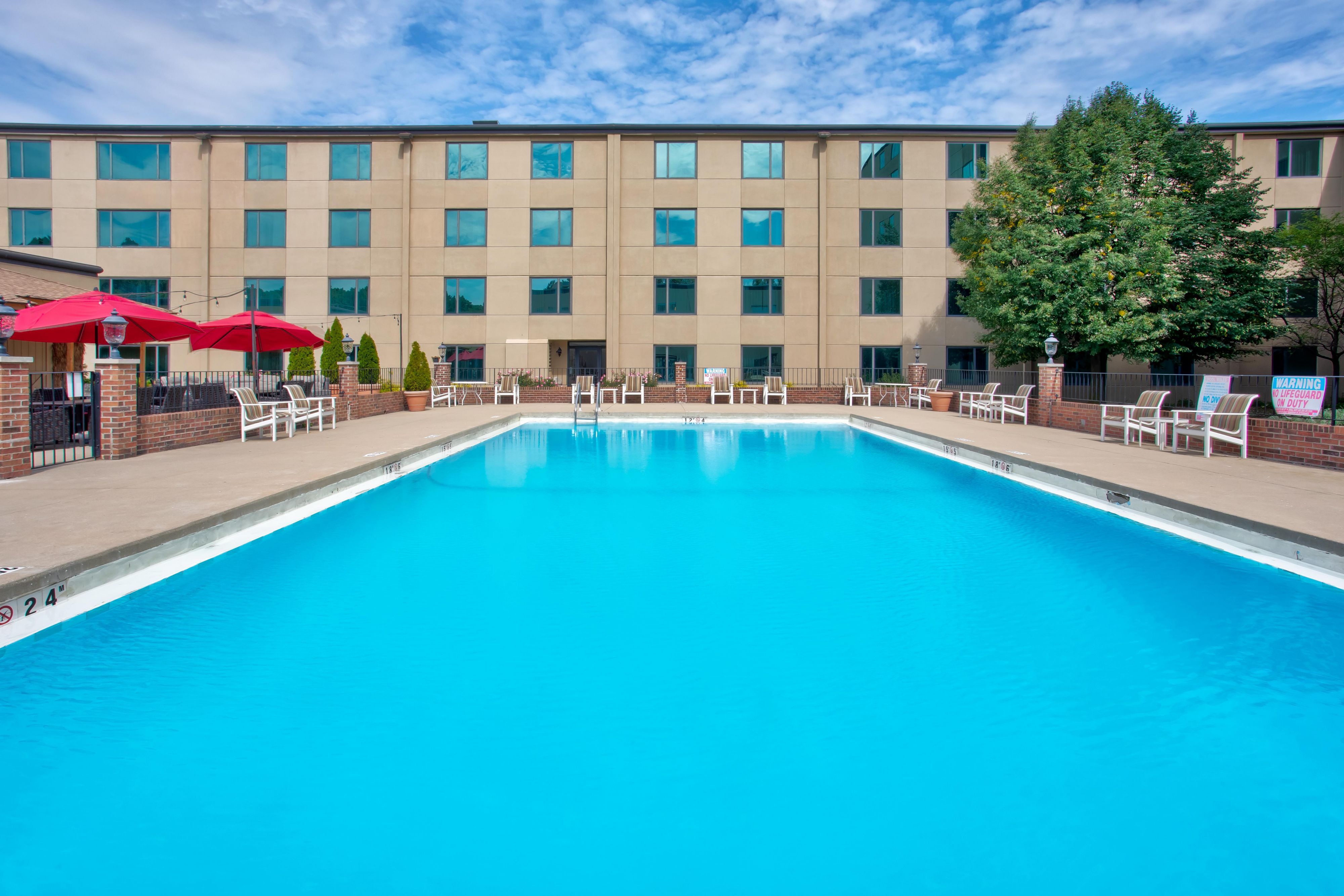 Outdoor pool with a patio space and plenty of seating