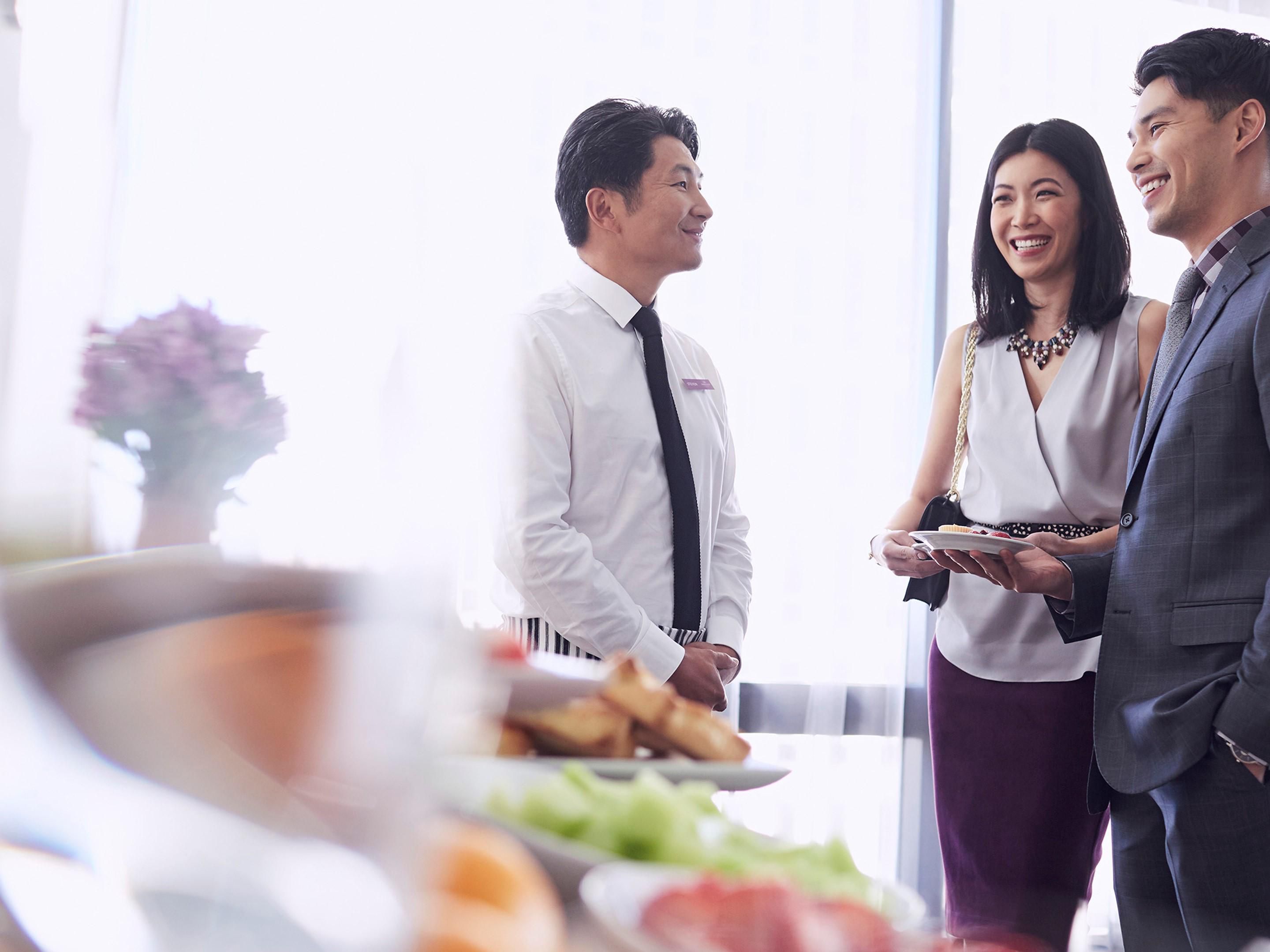 Waiter catering to the guests every need
