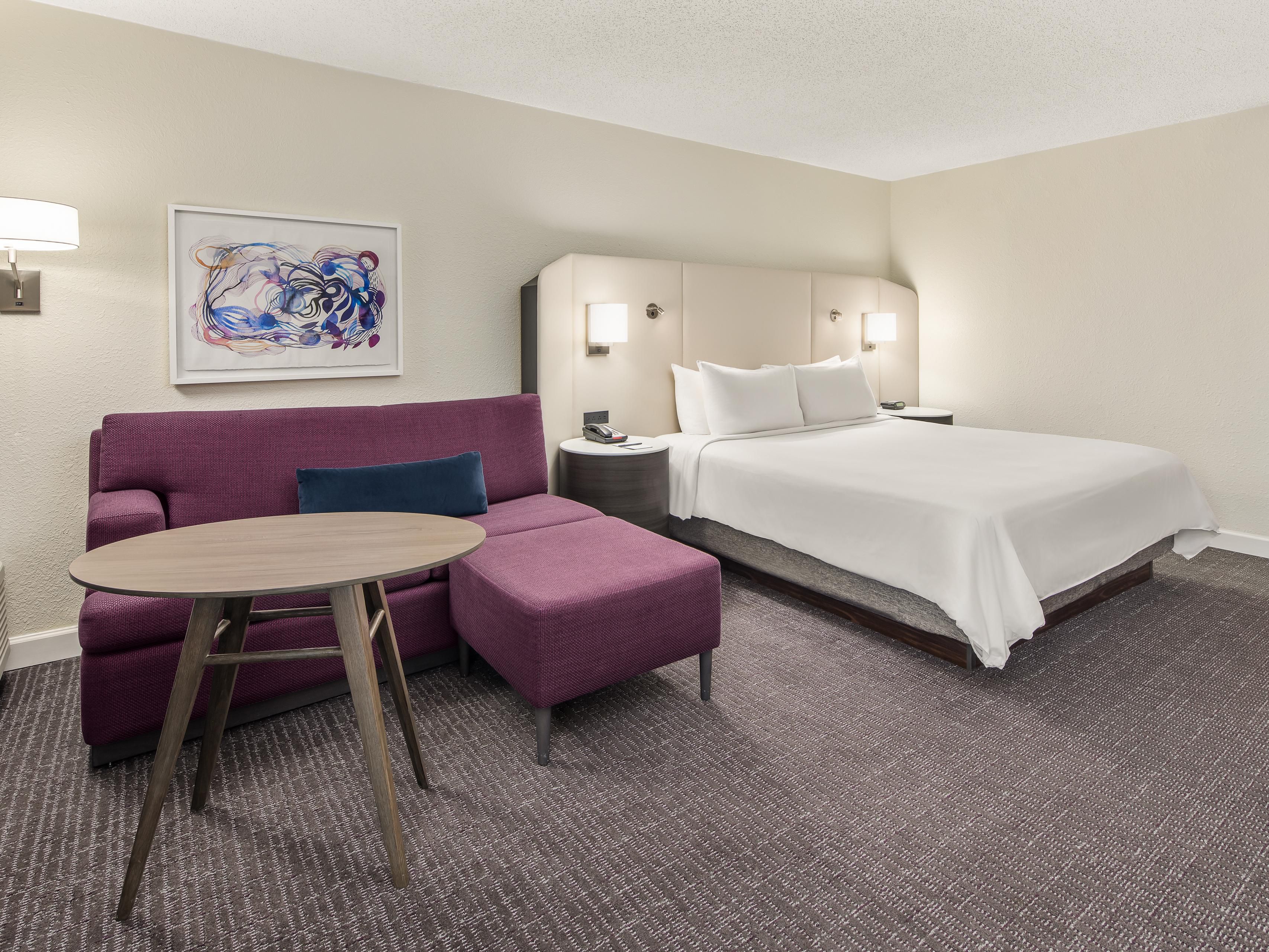 Experience the harmony of work and relaxation in our modern and stylish guest rooms. Designed for artful aesthetics and comfort, our standard rooms offer plush bedding with a cocooning headboard, a dynamic sofa nook, and spacious workstations. Select rooms feature a balcony. We provide the perfect balance of work, play, and a relaxing stay.