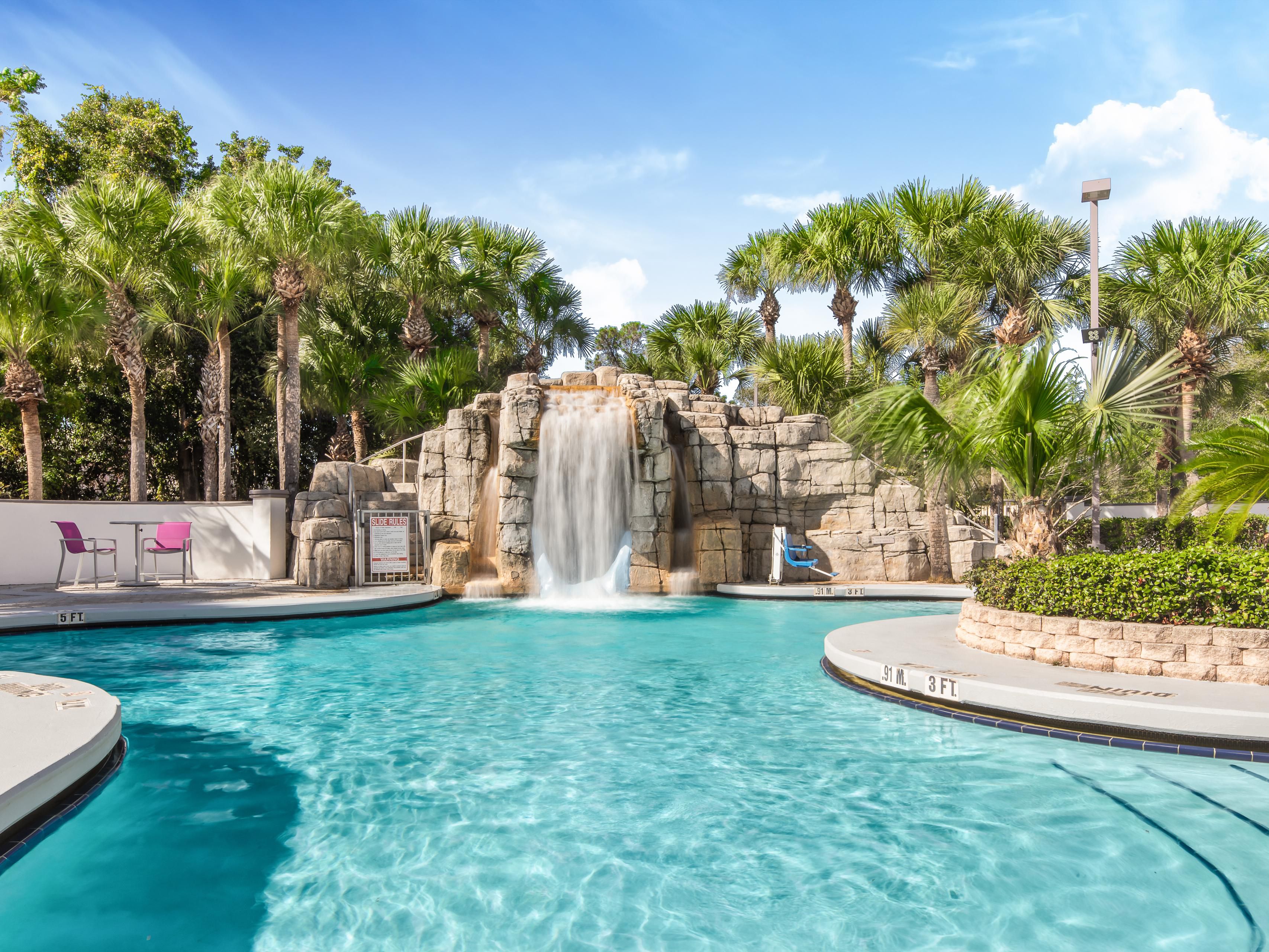 Relax by our inviting outdoor pool surrounded by lush palms and a cascading waterfall. Kids will love the 50-foot waterslide, while adults can soak up the Florida sunshine or lounge on the patio. It's the perfect spot for fun and relaxation in Orlando! Pool open 9:00 AM – 11:00 PM.
