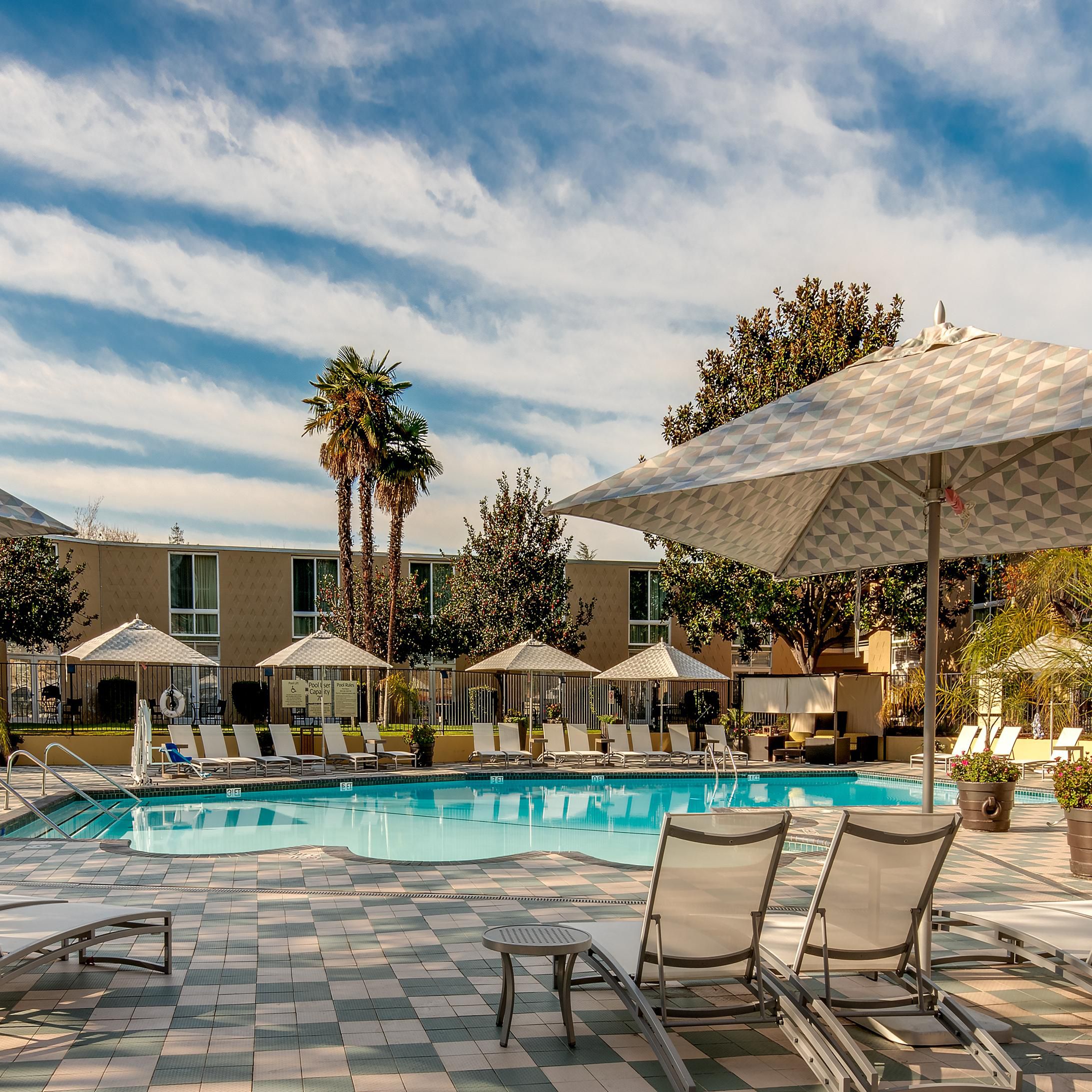 Unwind in our outdoor heated pool and relax on the large pool deck