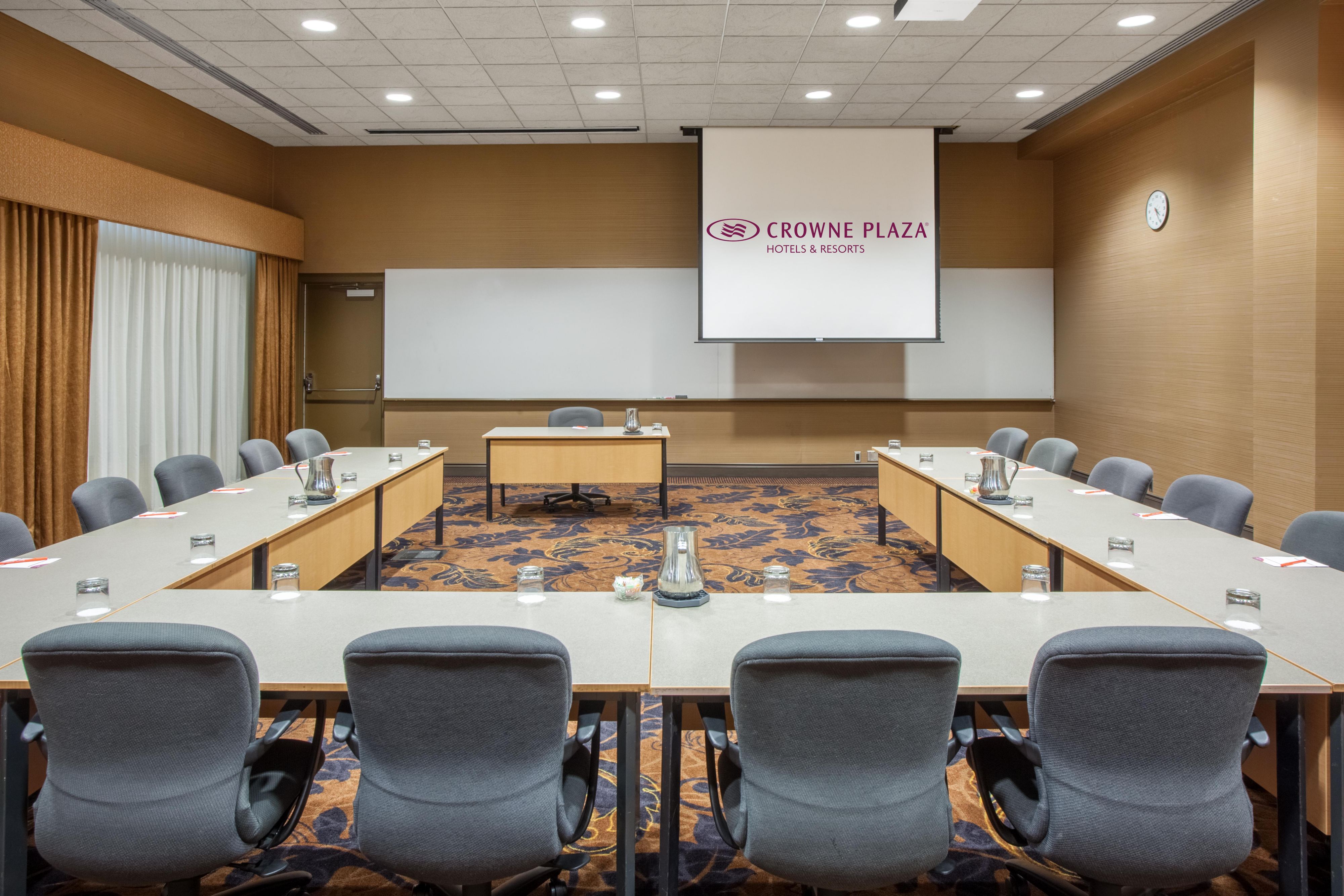 Conference Room F with long tables and projector screen