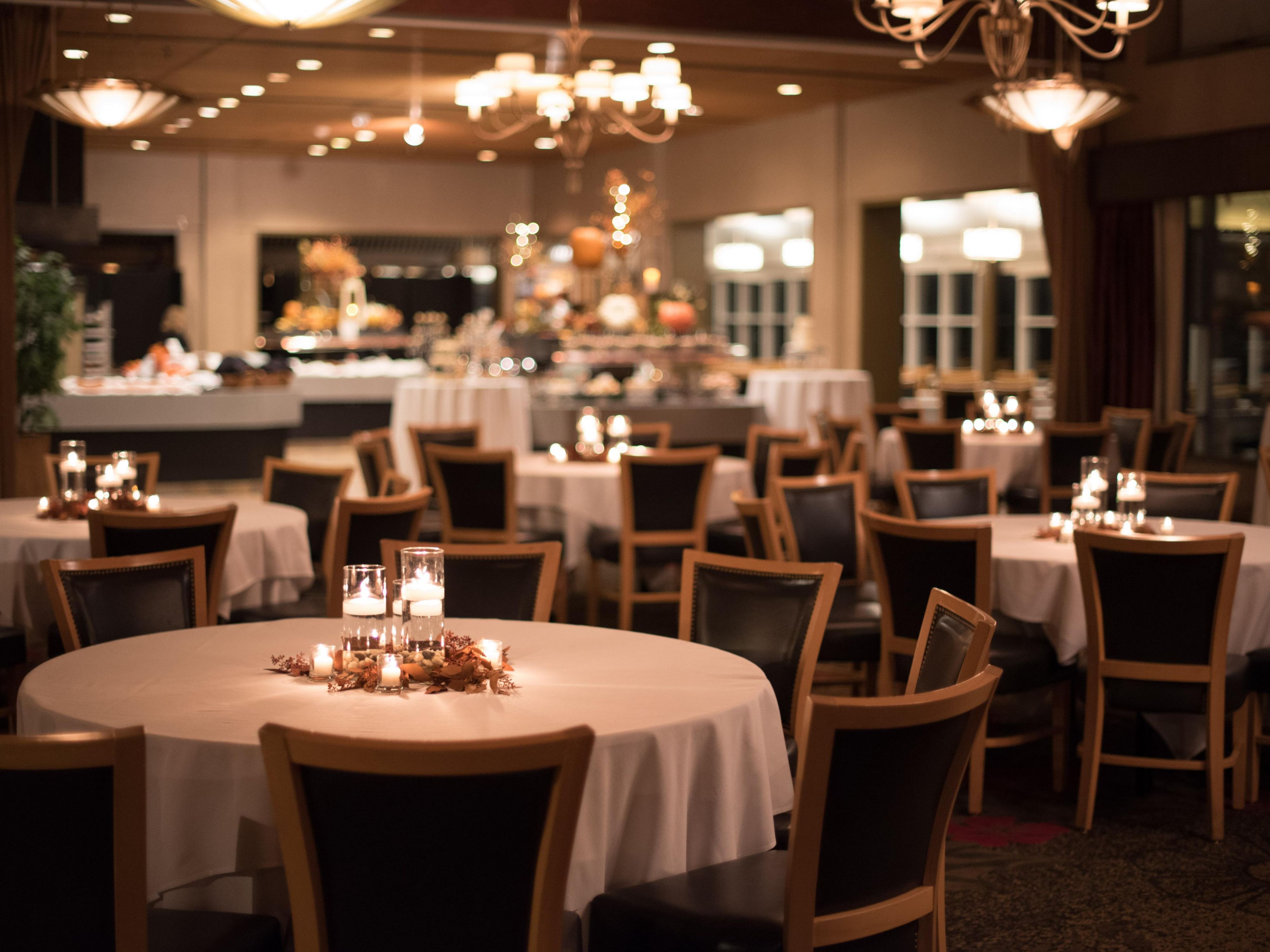 Wedding setup with circular tables and dim lighting