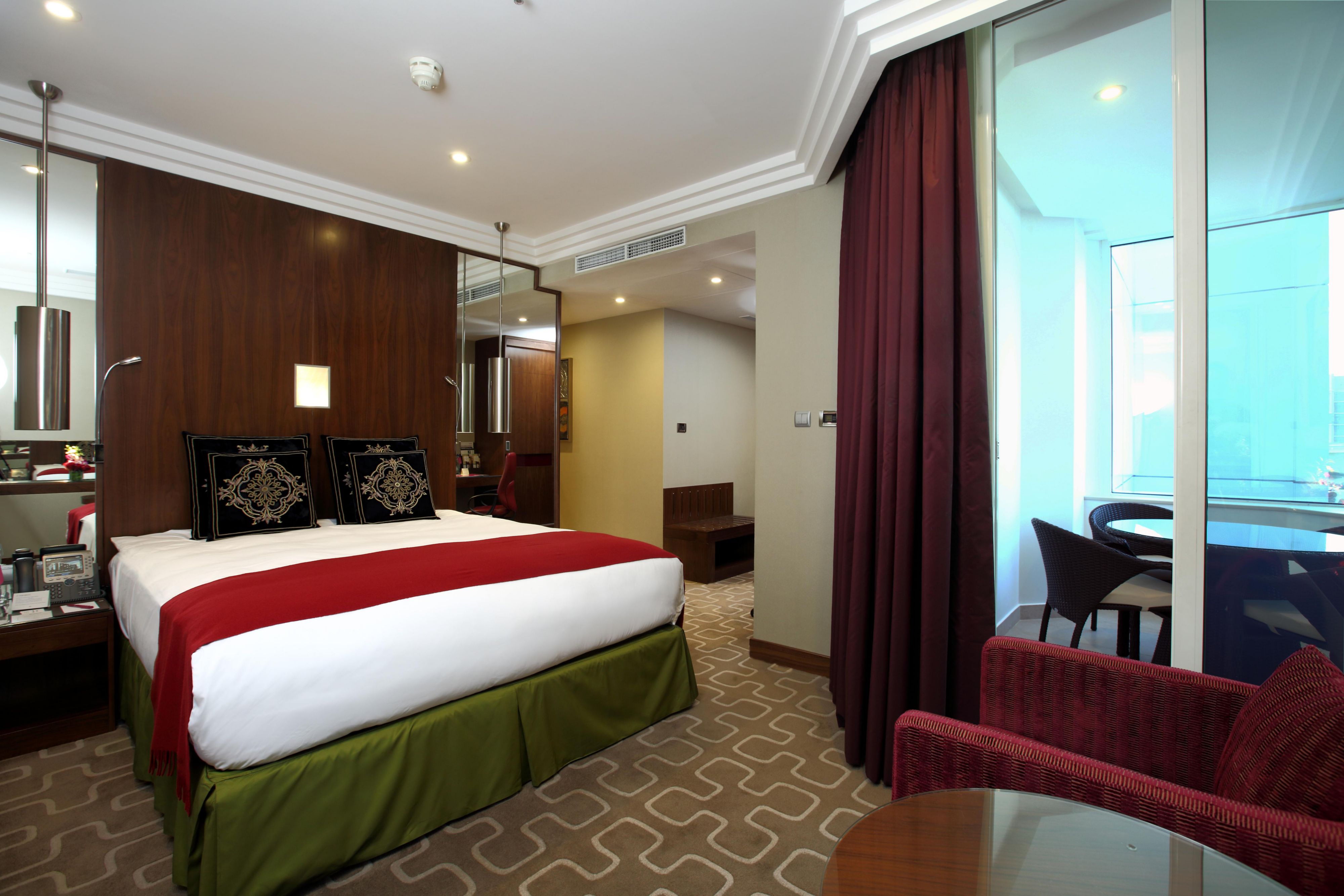 Spacious bedroom with balcony access in the Ambassador Suite