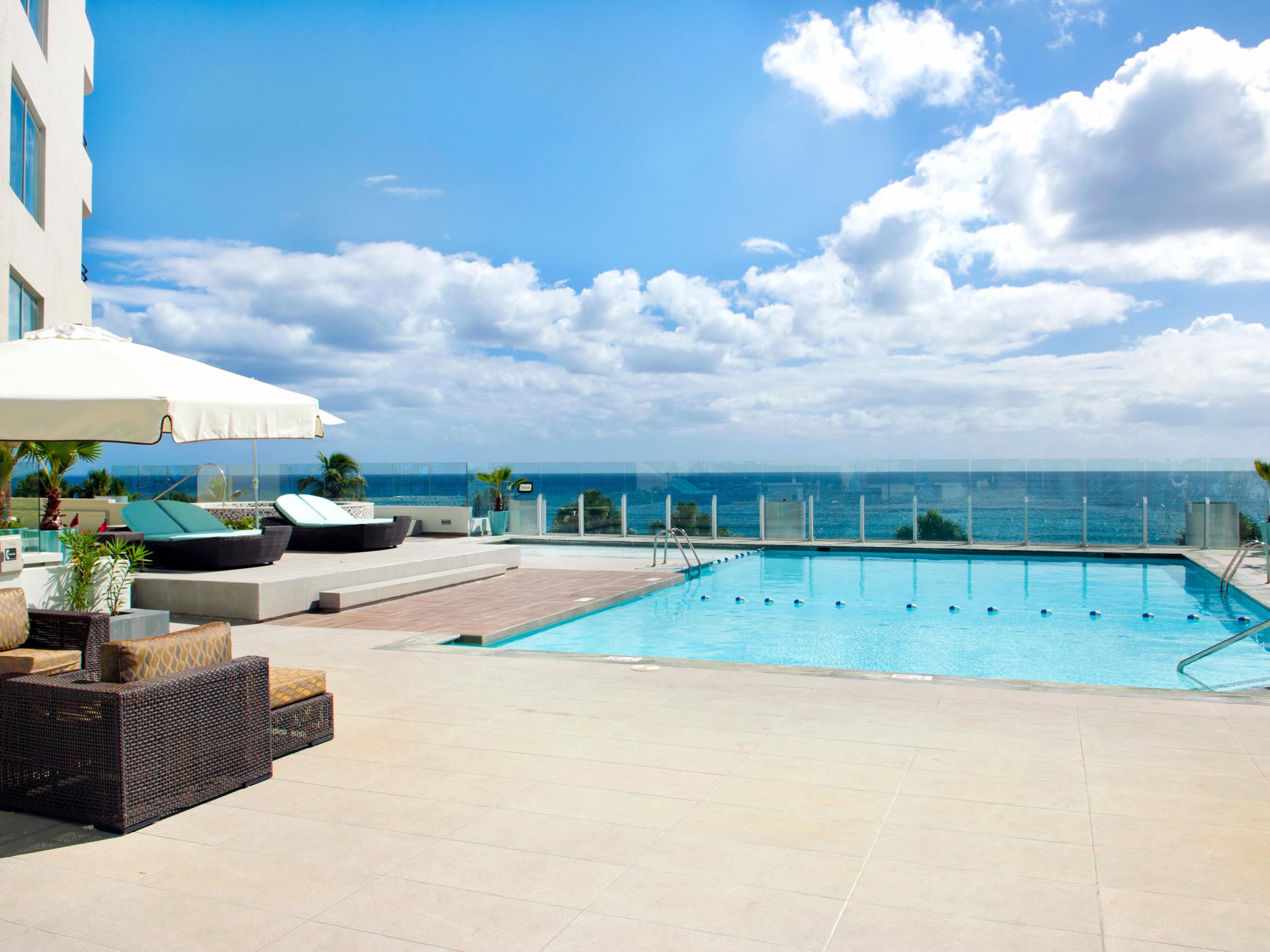 Immerse yourself in relaxation at our stunning rooftop pool, a serene oasis overlooking the Caribbean Sea. Unwind with a cocktail from Las Olas Pool Bar, bask in the sun, or enjoy the rhythmic sounds of the waves, all in our luxurious, resort-style setting.