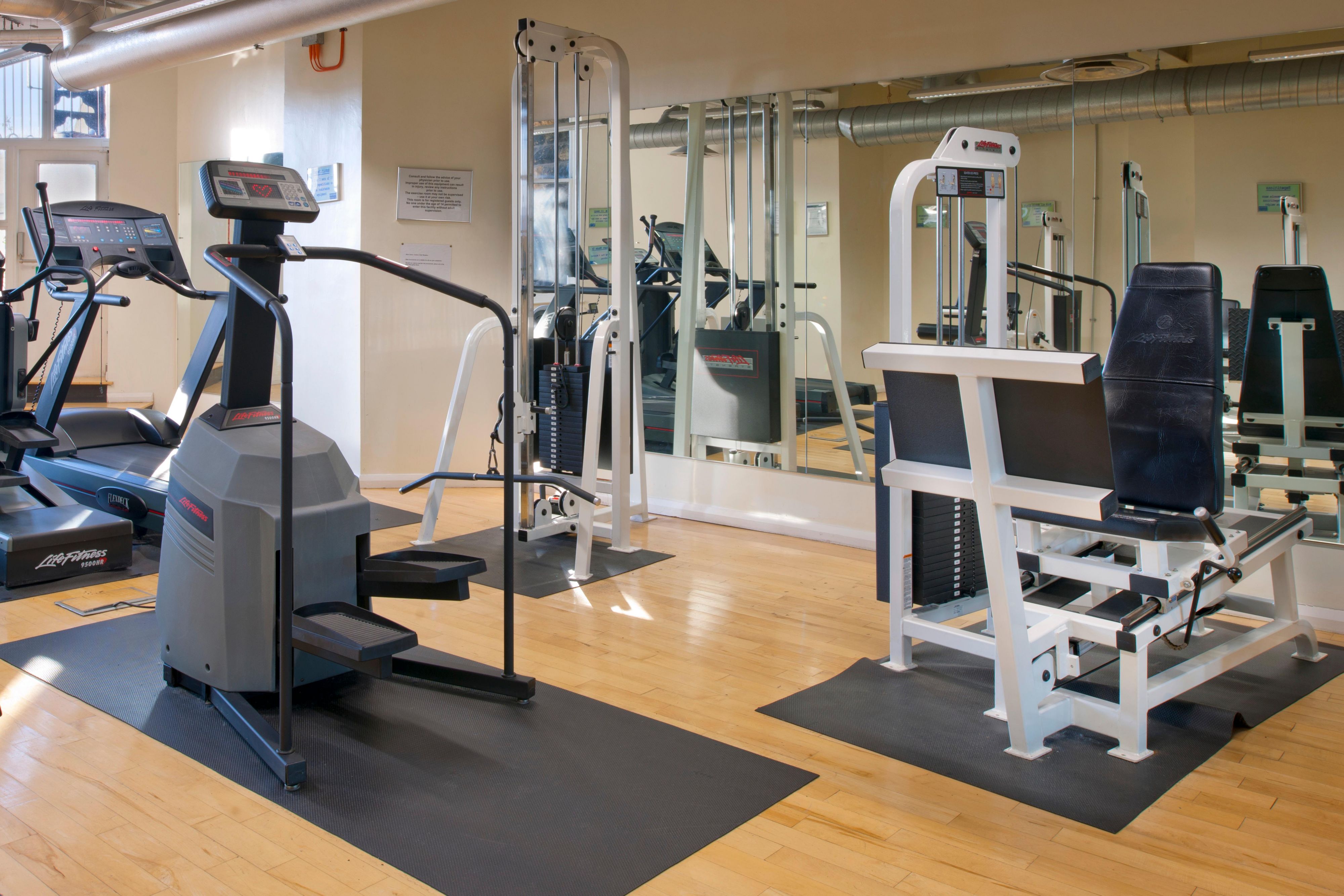 fitness center workout area with flatscreen tv's
