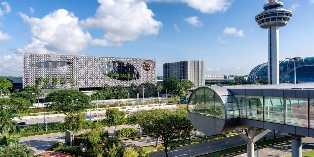 Outdoor view of terminal 3 at the airport with Crowne Plaza hotel
