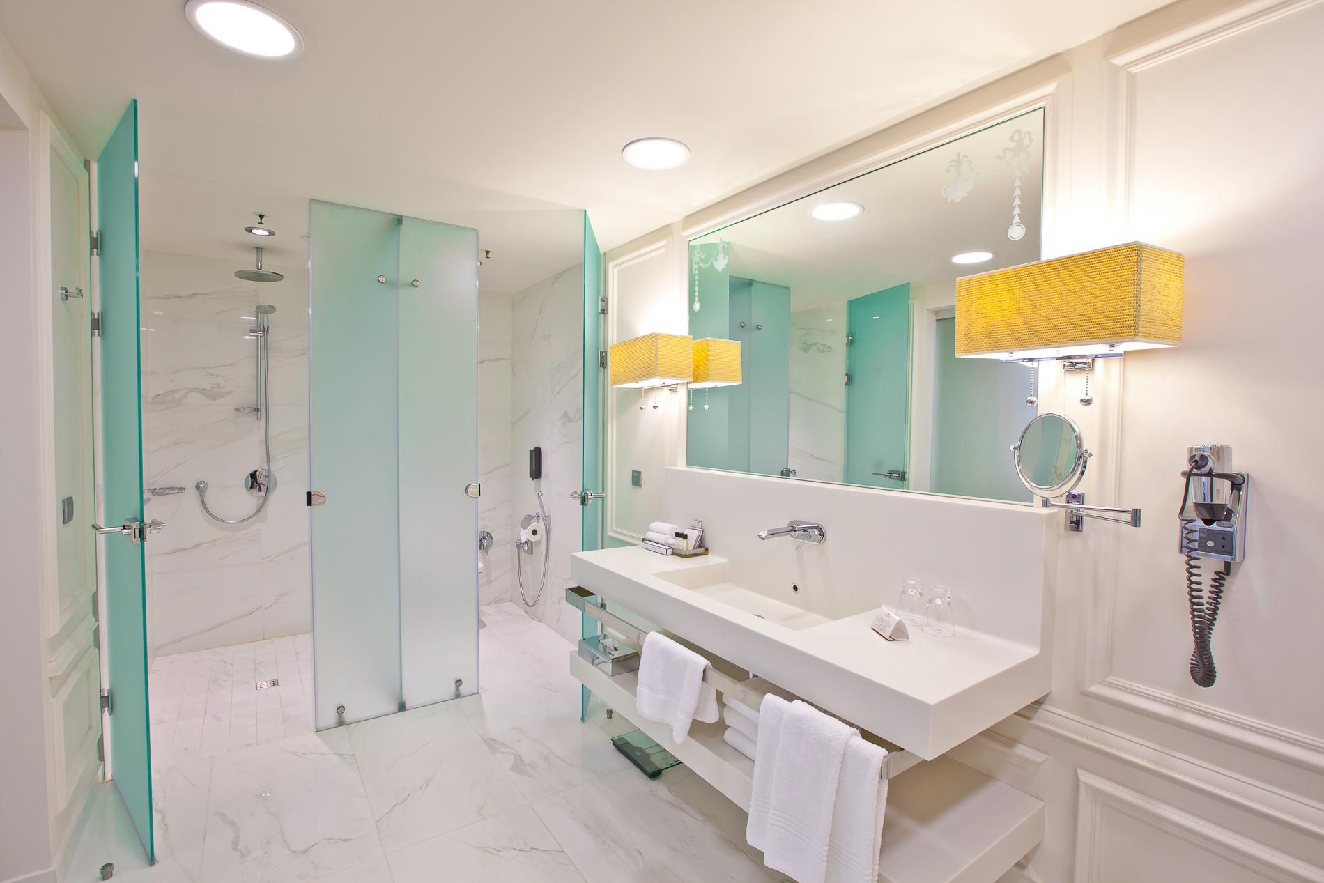 Spacious white bathroom in hotel Deluxe room