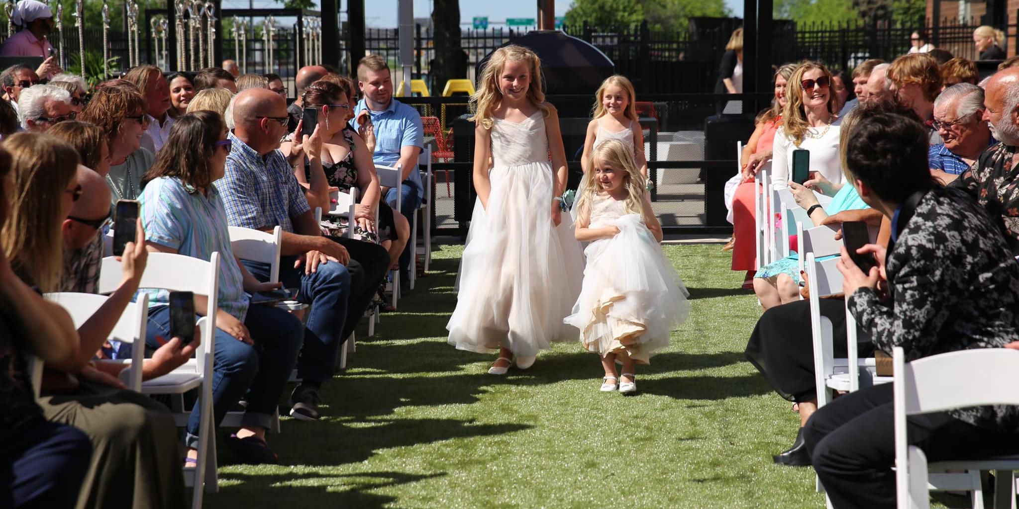 Flower girls walking down the isle at a wedding