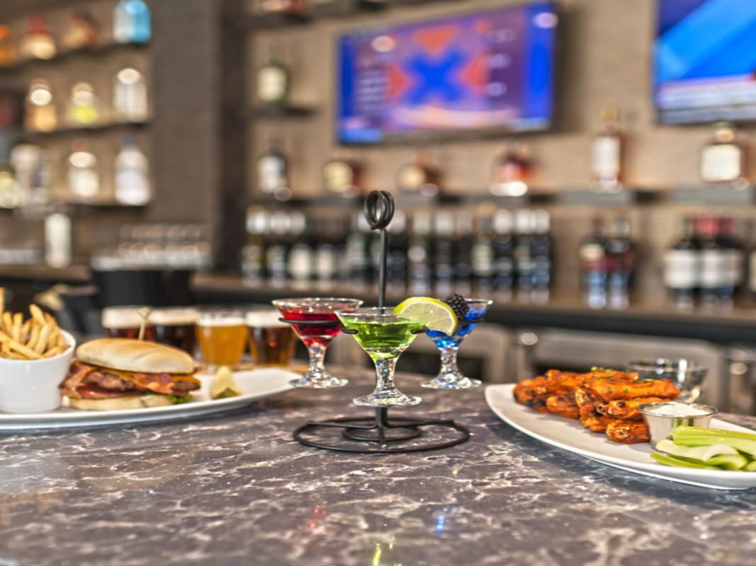 Savor American cuisine at AiRECraft Grill, serving all-day dining options. From mouthwatering nachos to flavorful burgers, sandwiches, and brick oven pizzas, we offer a wide range of options to tantalize your taste buds. Complement your meal with a crafted cocktail, beer, or wine from our bar. 