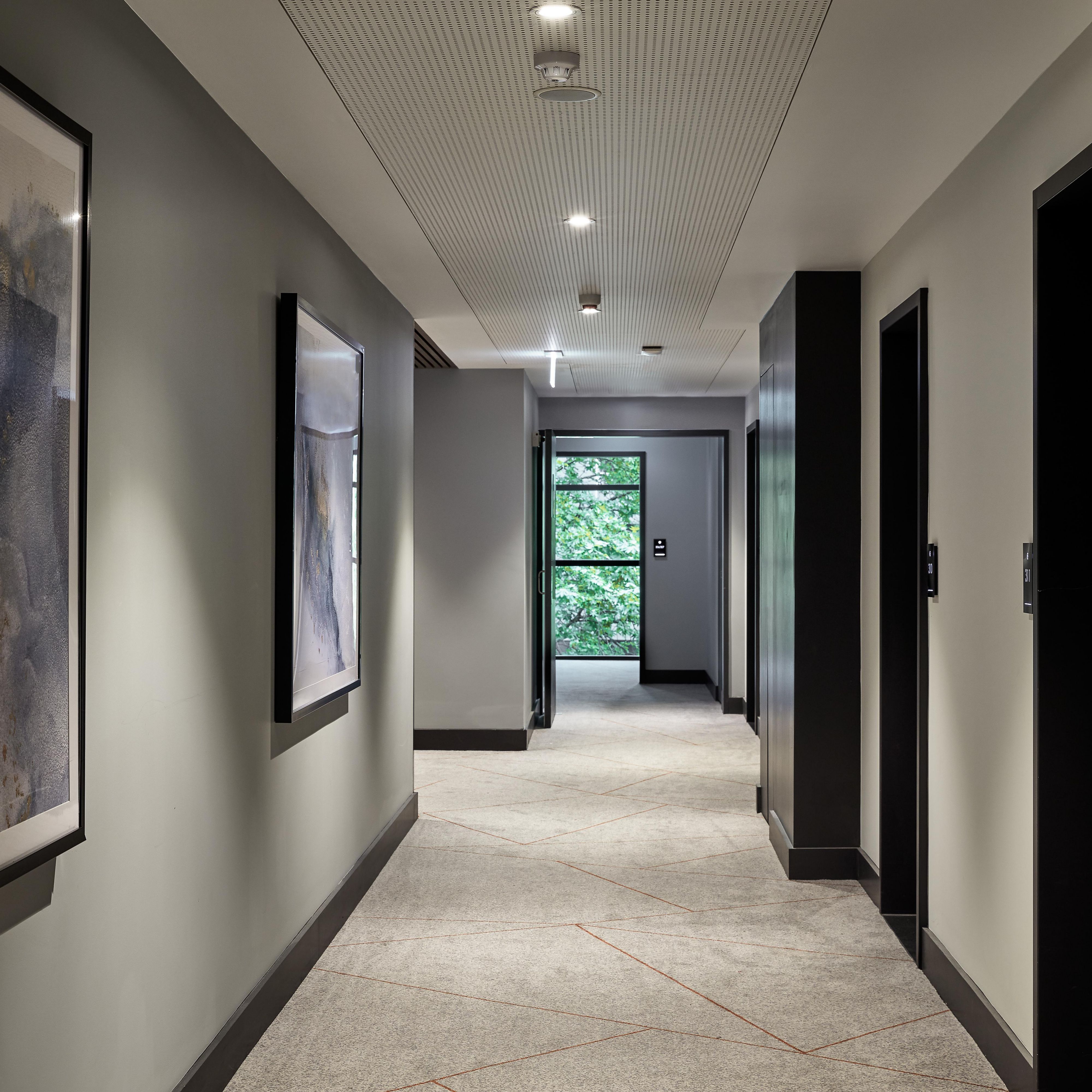 Acostic ceilings in guest hallways help with sound insulation
