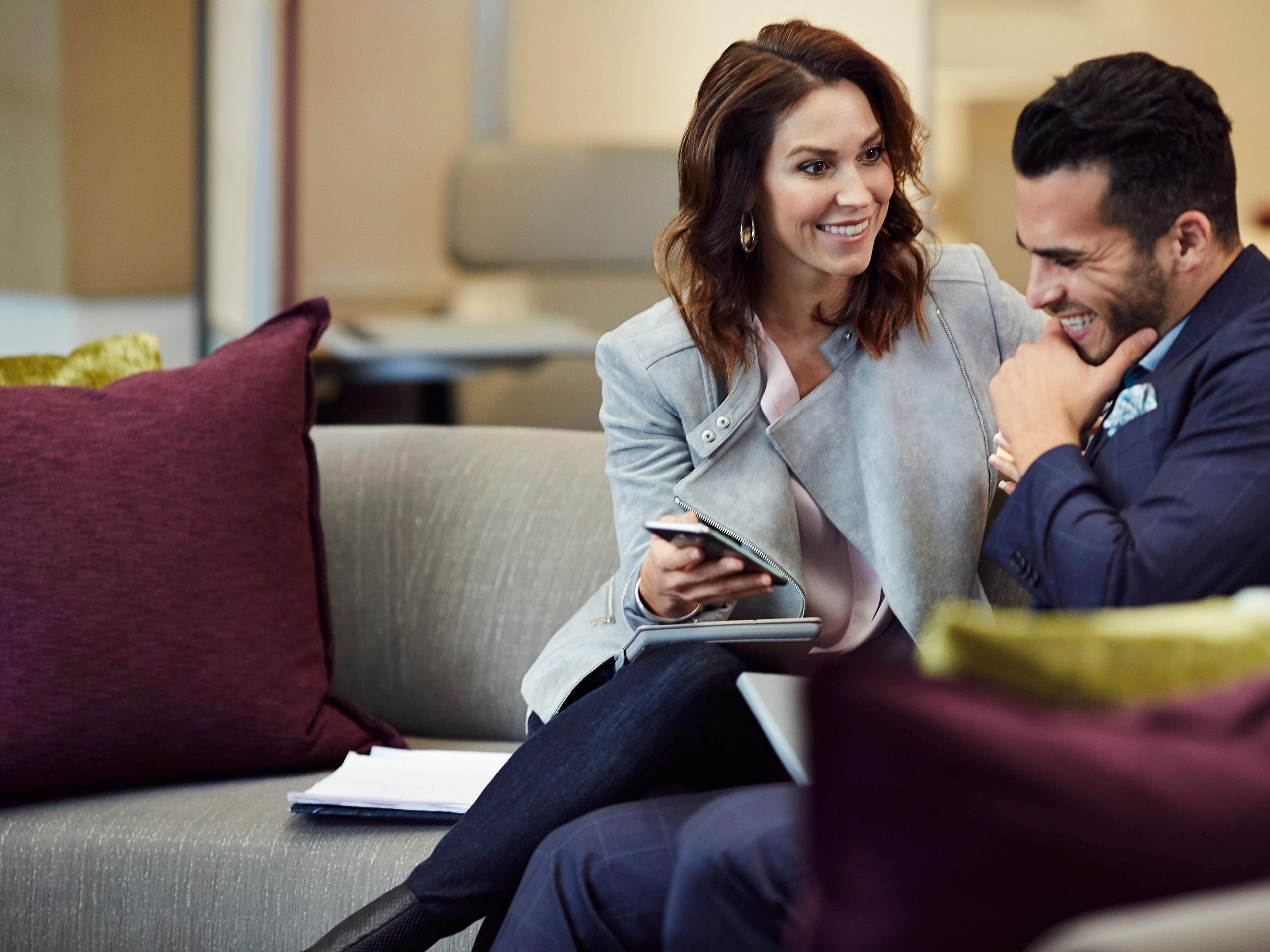 Woman showing man something on phone