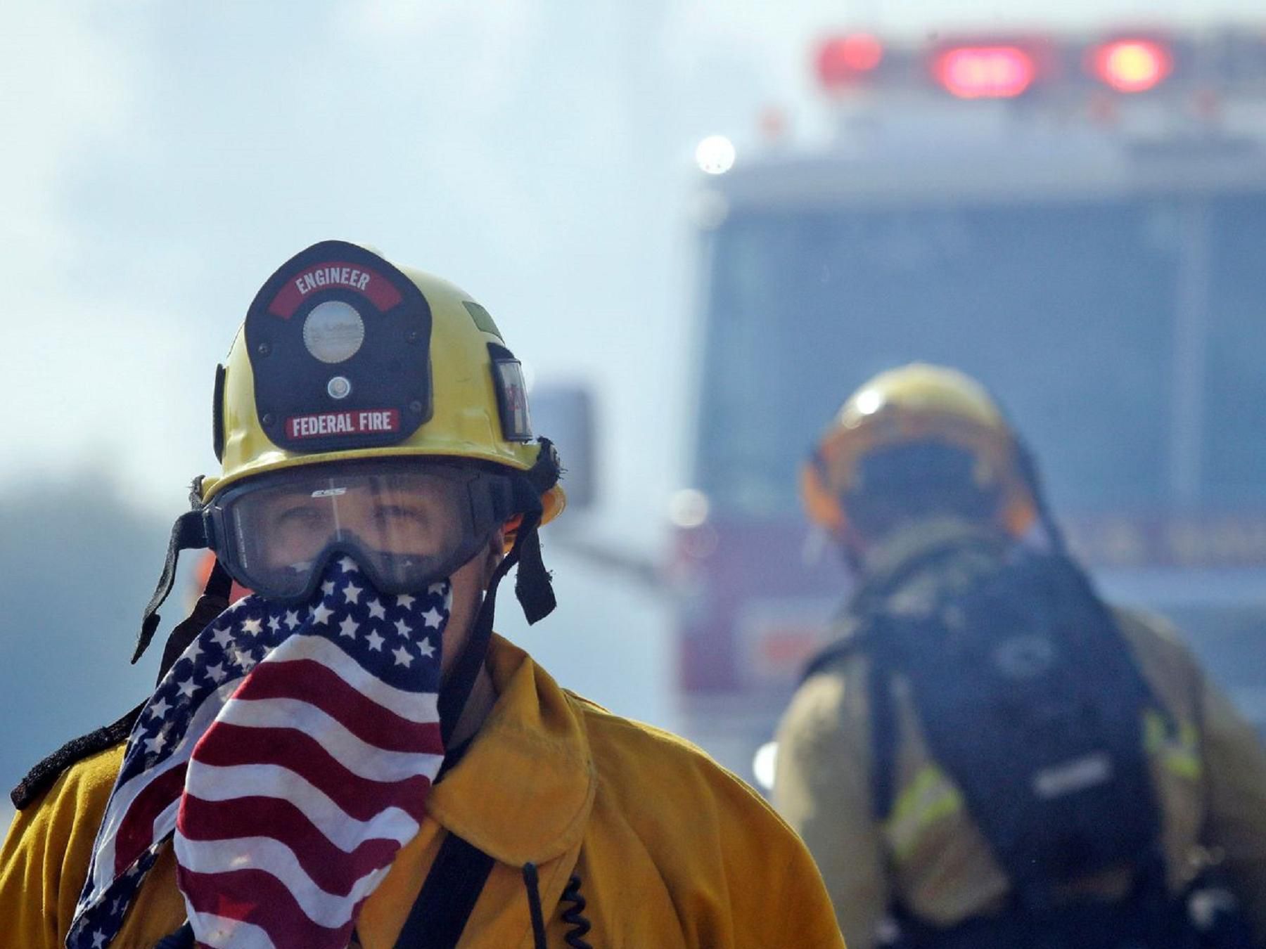 Firefighters surrounded by smoke
