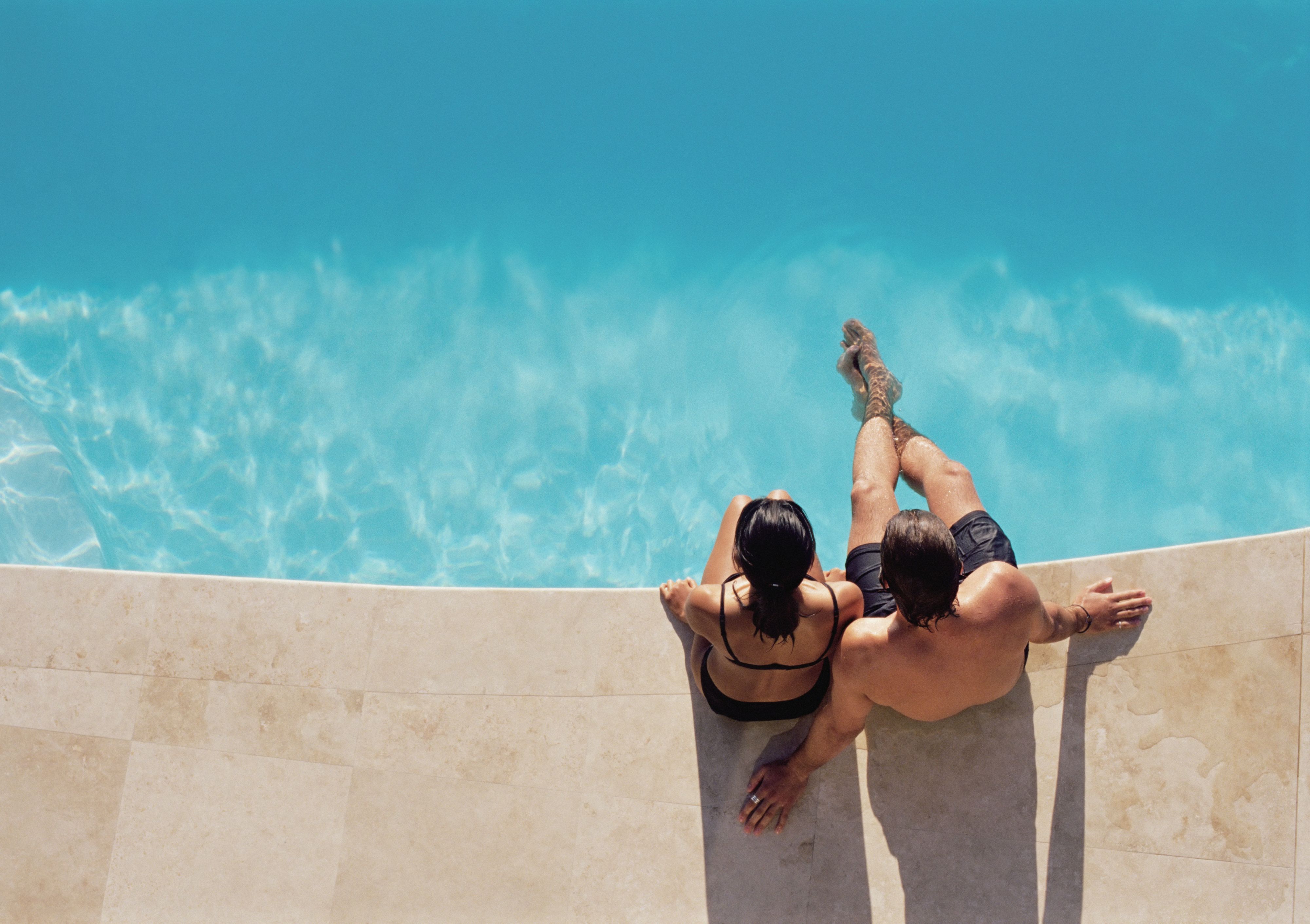 Couple lounging by the pool