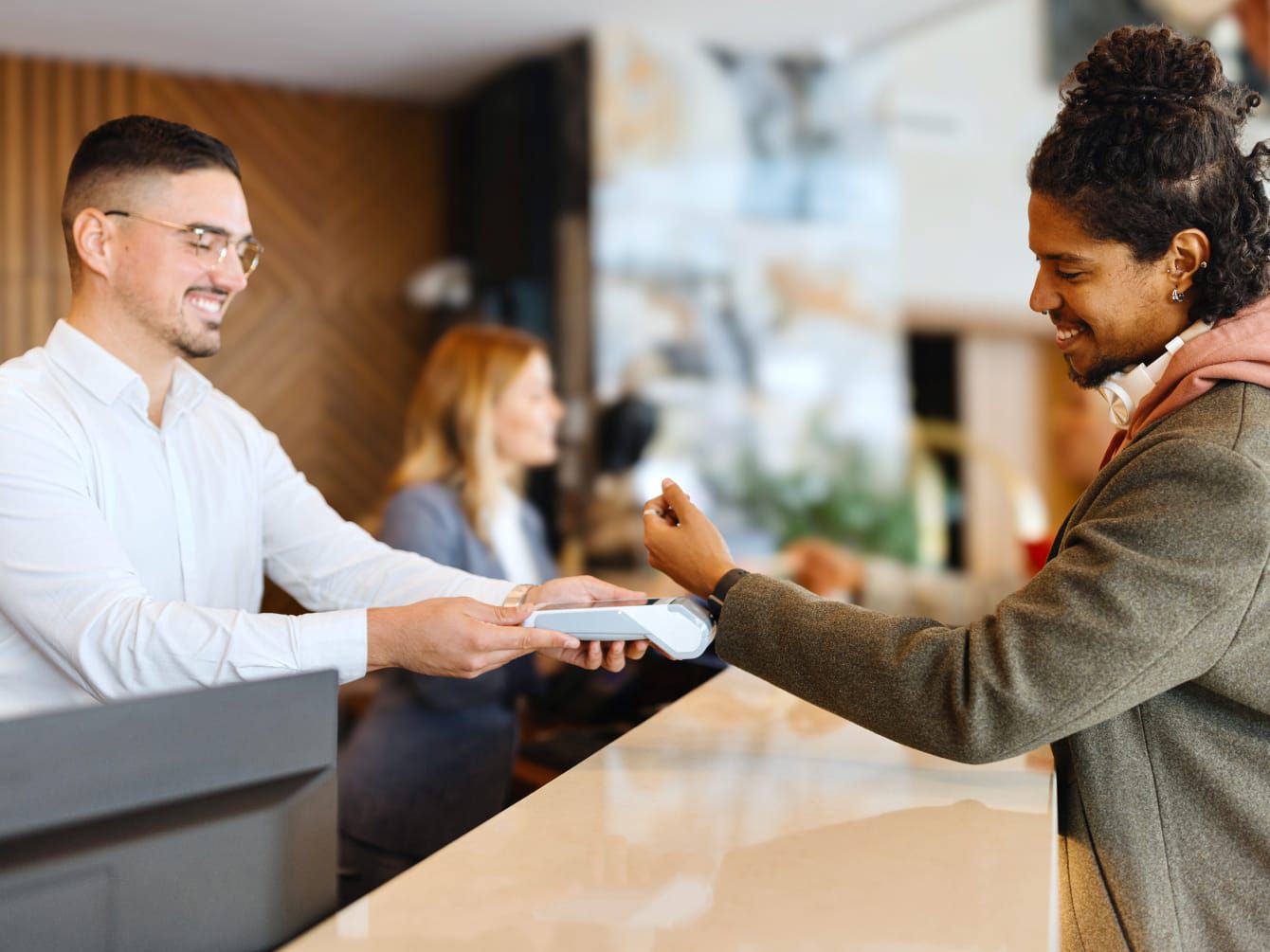 Man paying with smart watch at reception desk