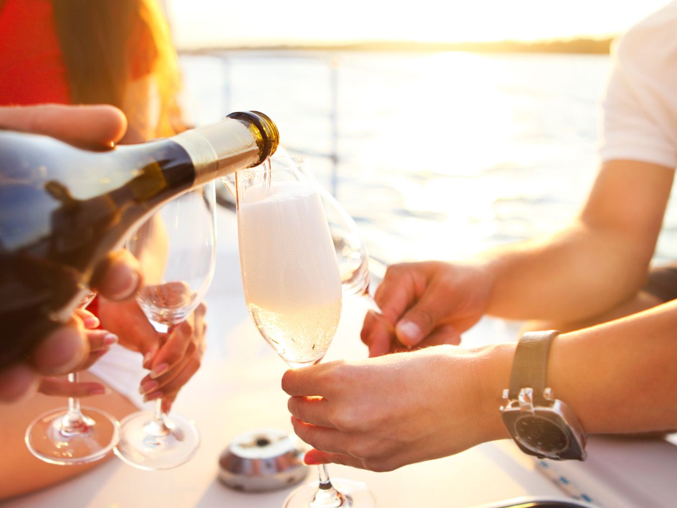 People enjoying glass of champagne on catamaran