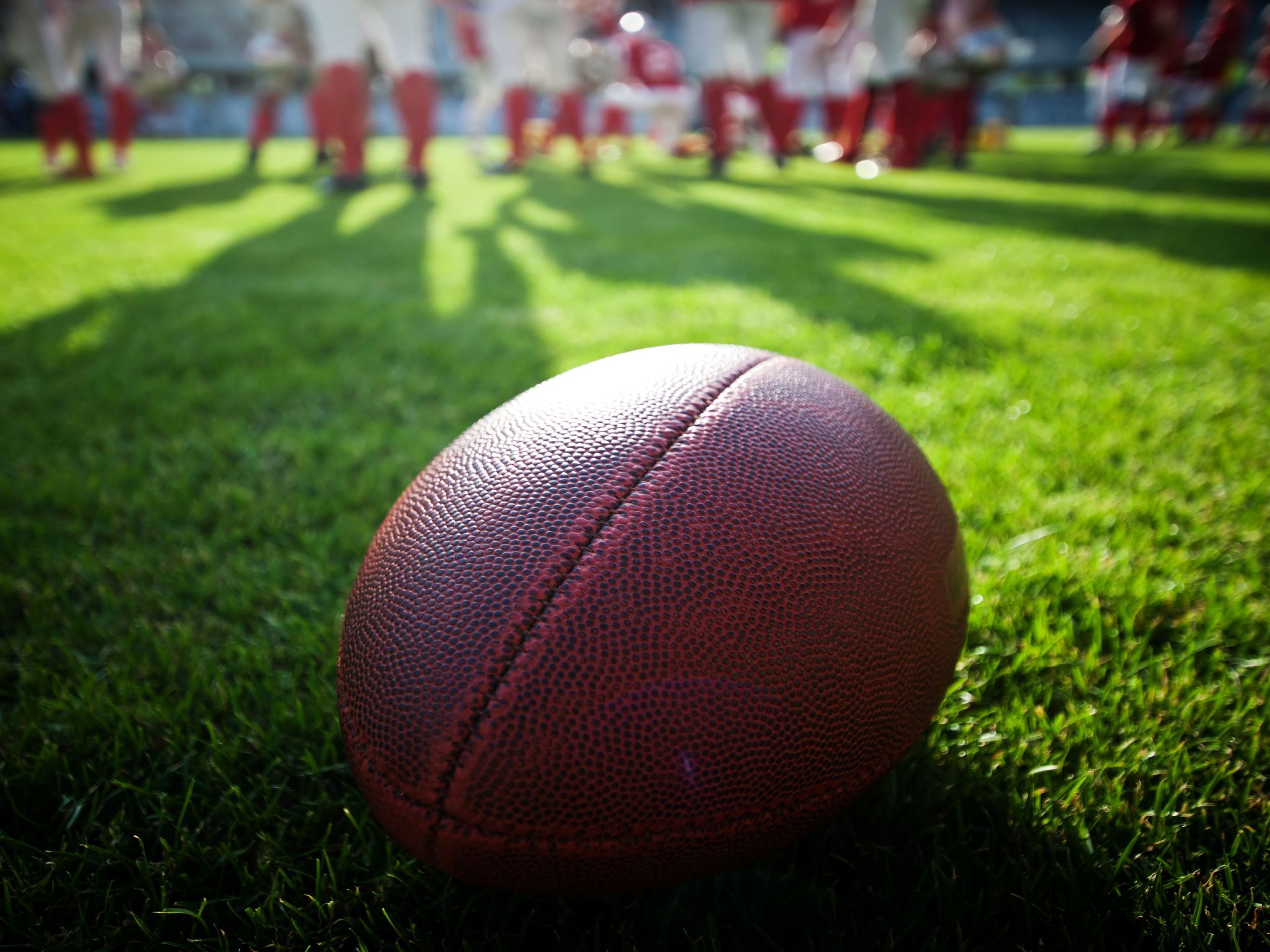 football on a field with players in background