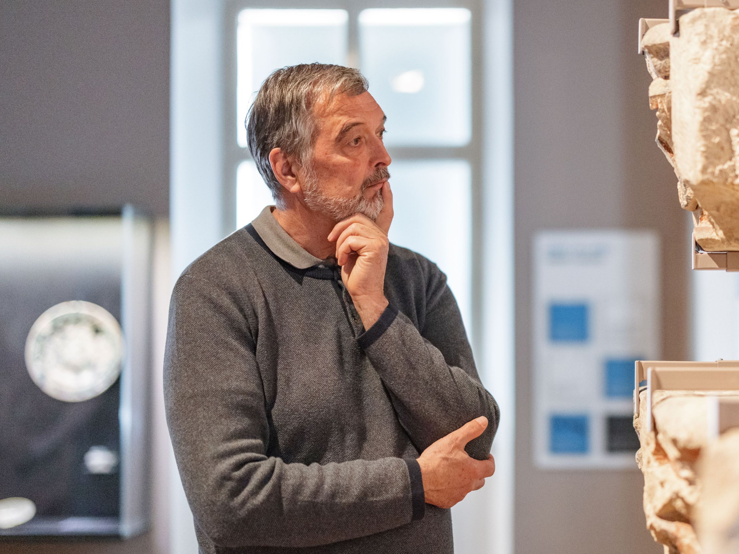 Man looking at artifacts in museum