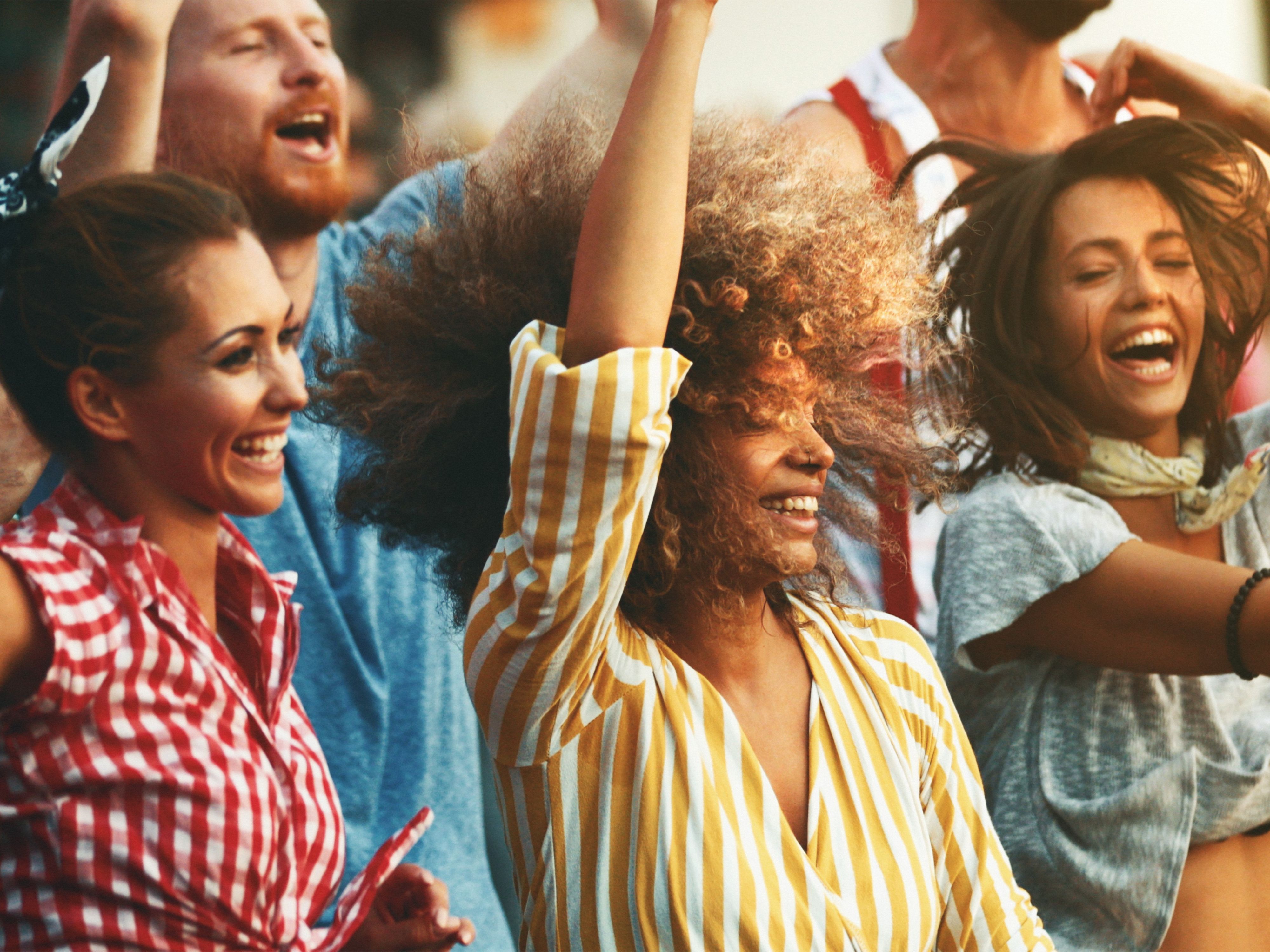 Friends dancing in a crowd
