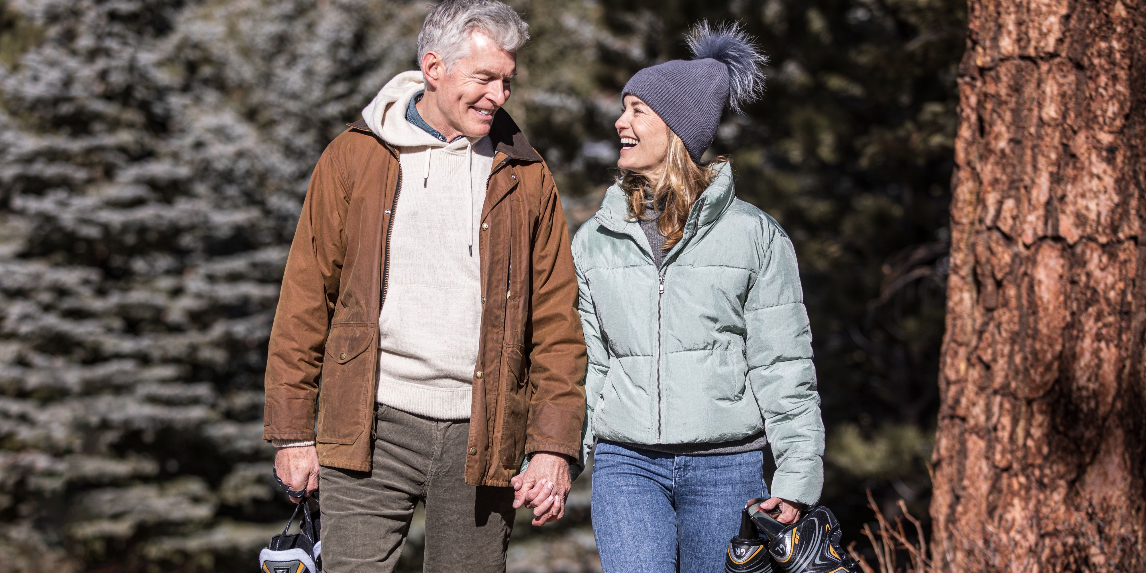 Couple walking with ice skates holding hands