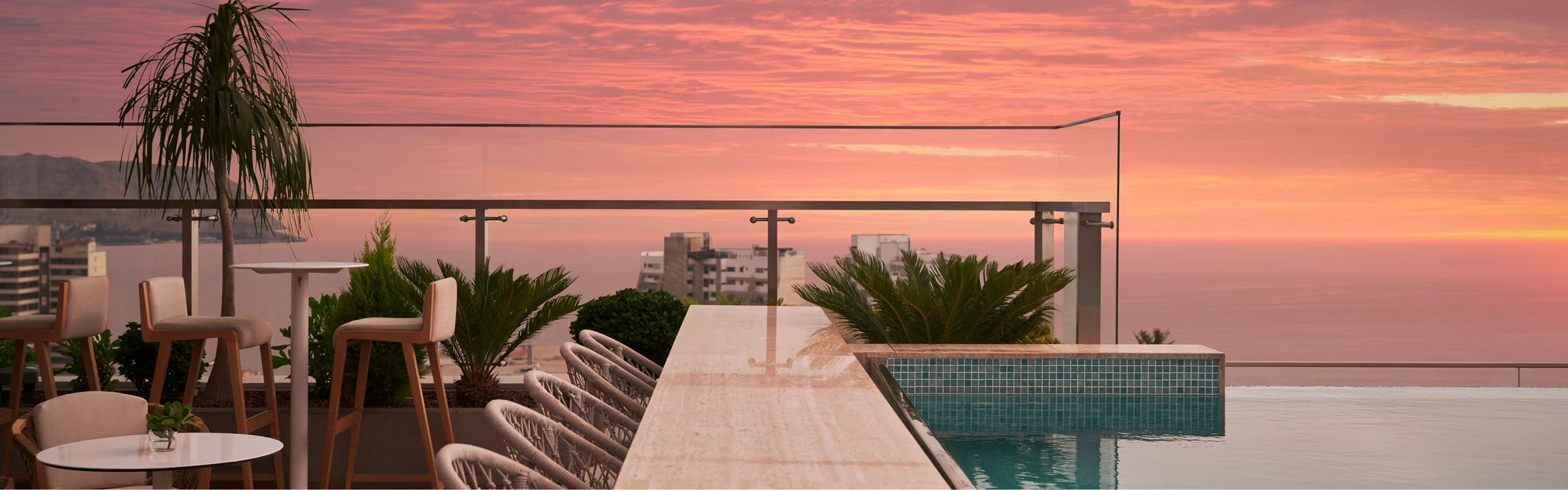 SOUMA Lima Vignette Collection pool side with chairs & tables, sunset