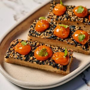 Gourmet appetizer with roasted tomatoes and sesame topping