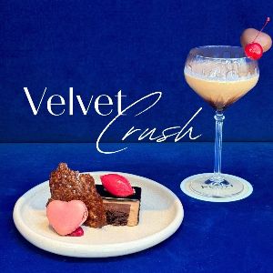 Elegant dessert and cocktail against vibrant blue backdrop