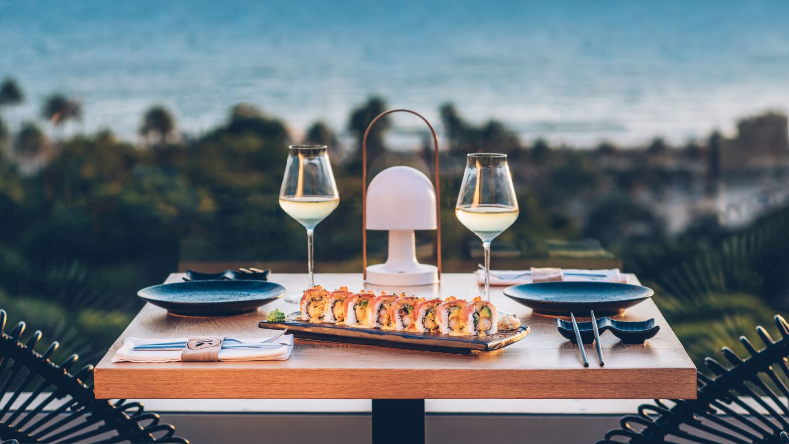 Image of sushi dinner seating for two overlooking beautiful beachfront