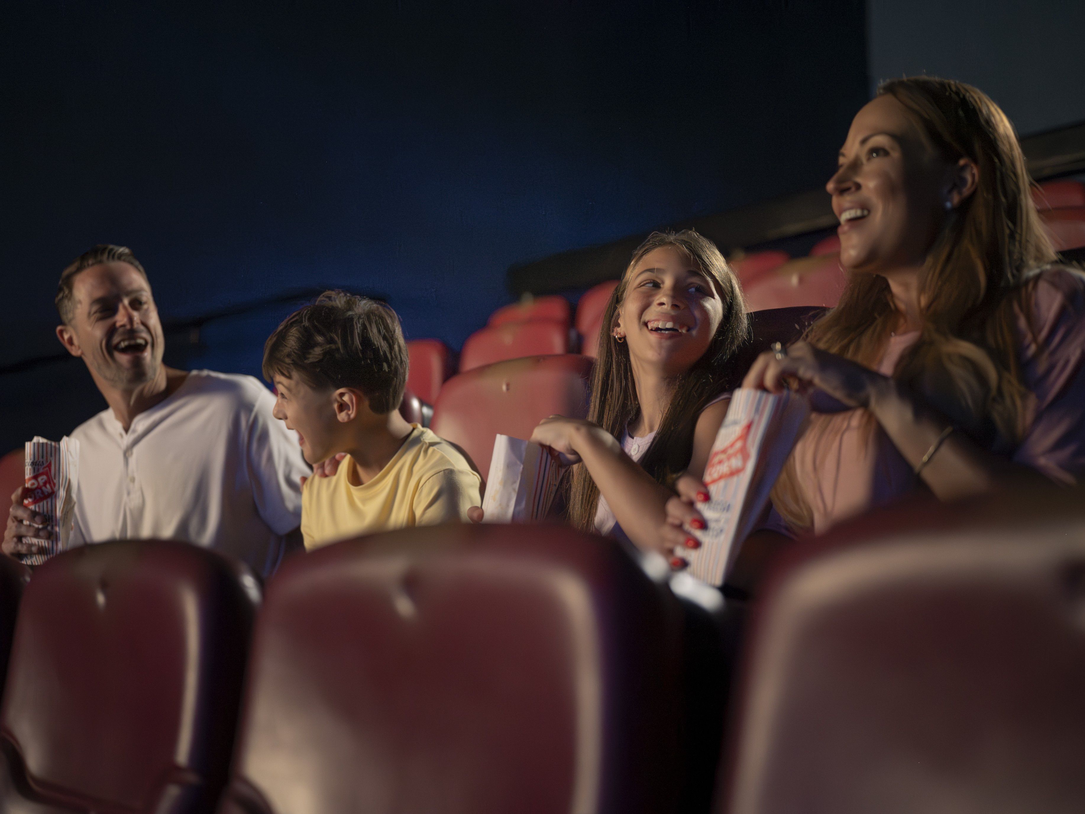 Family enjoying snacks in a movie theatre