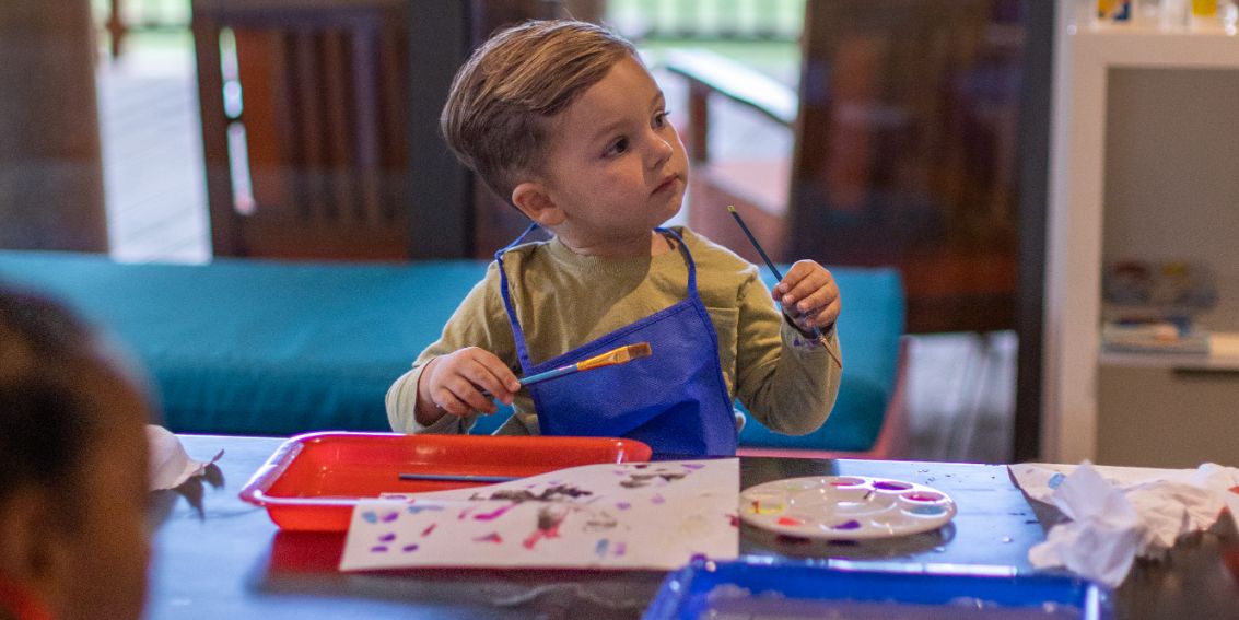 Boy painting at table