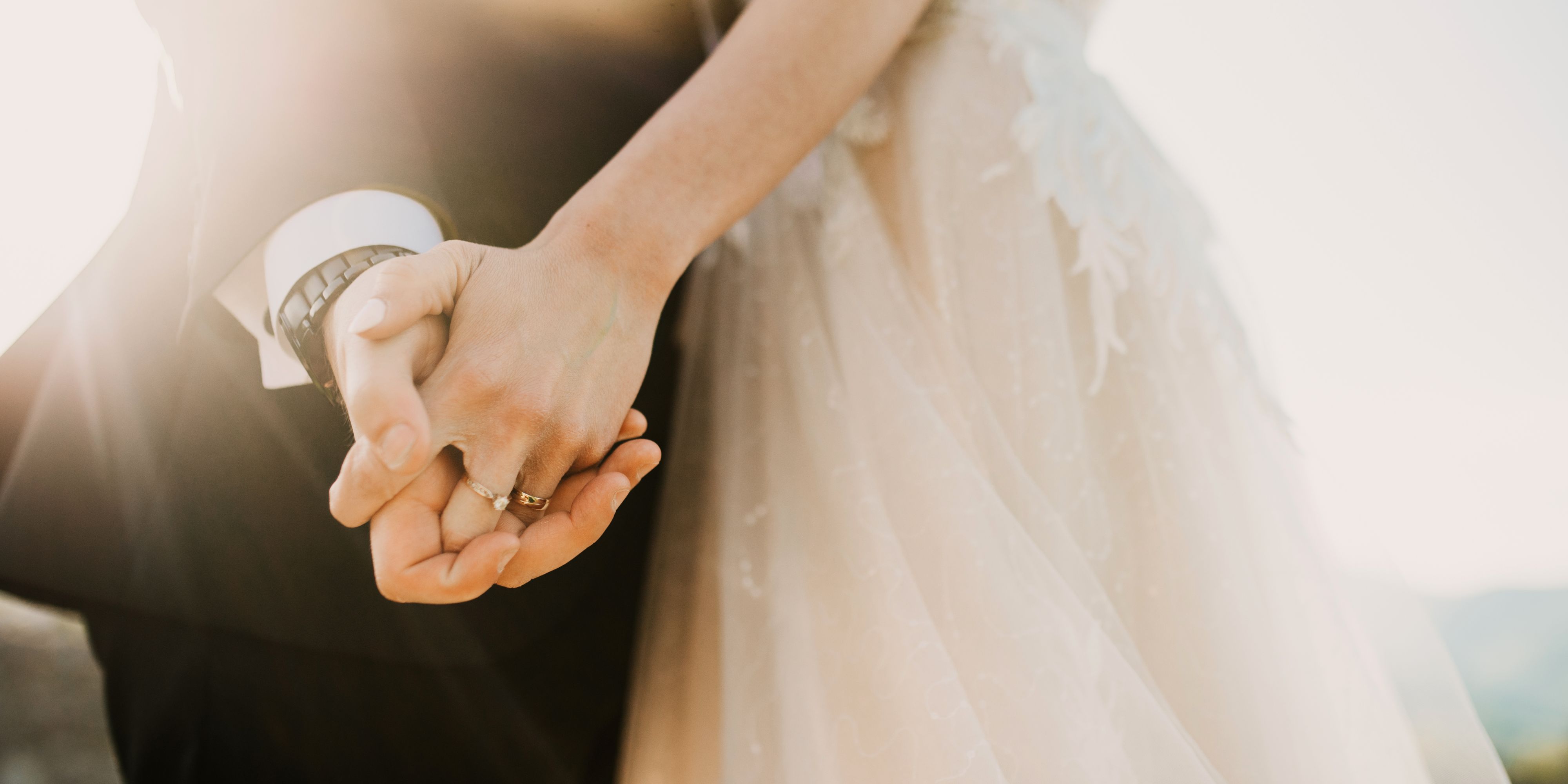 bride and groom holding hands