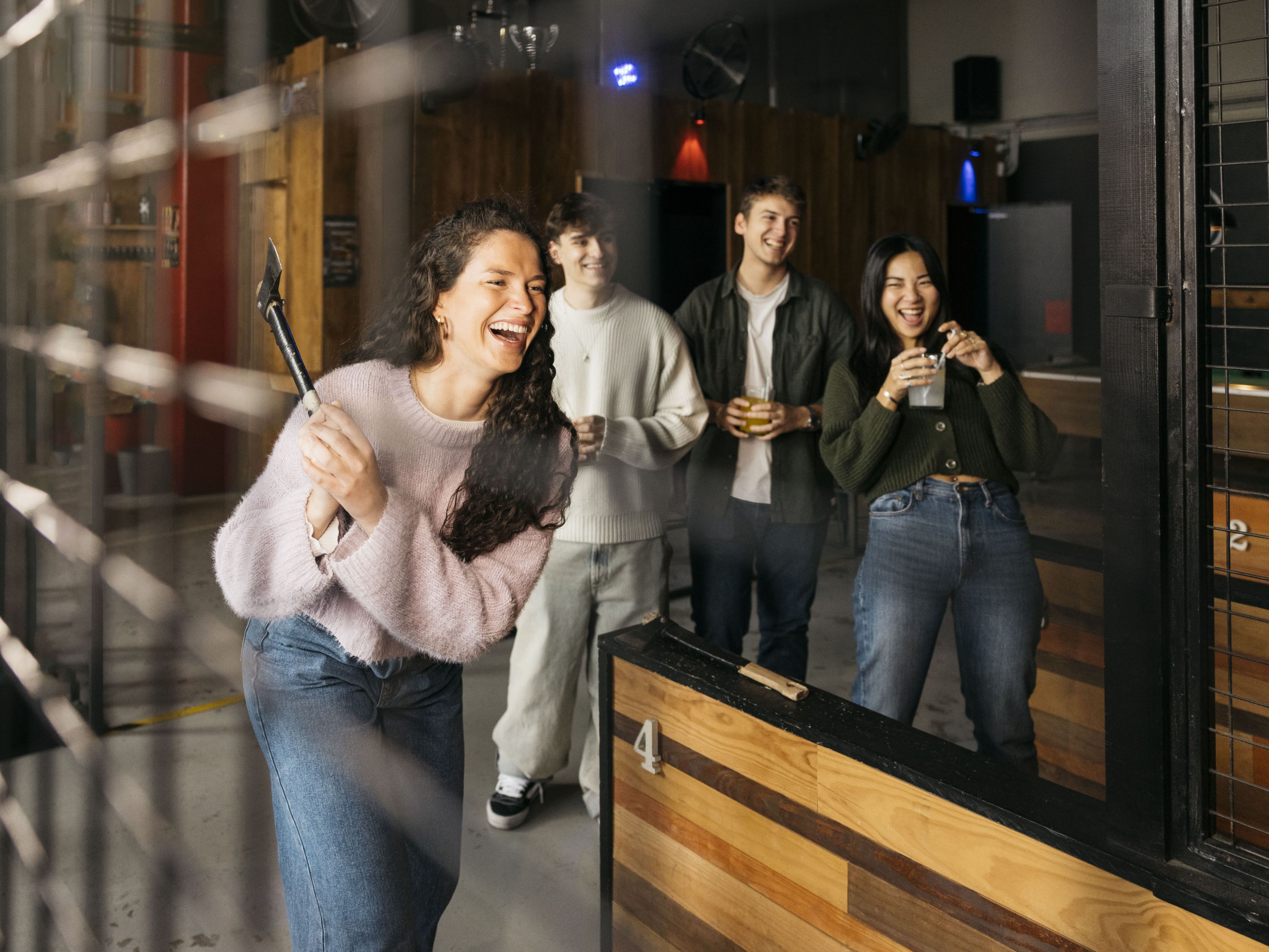 Group of friends axe throwing.