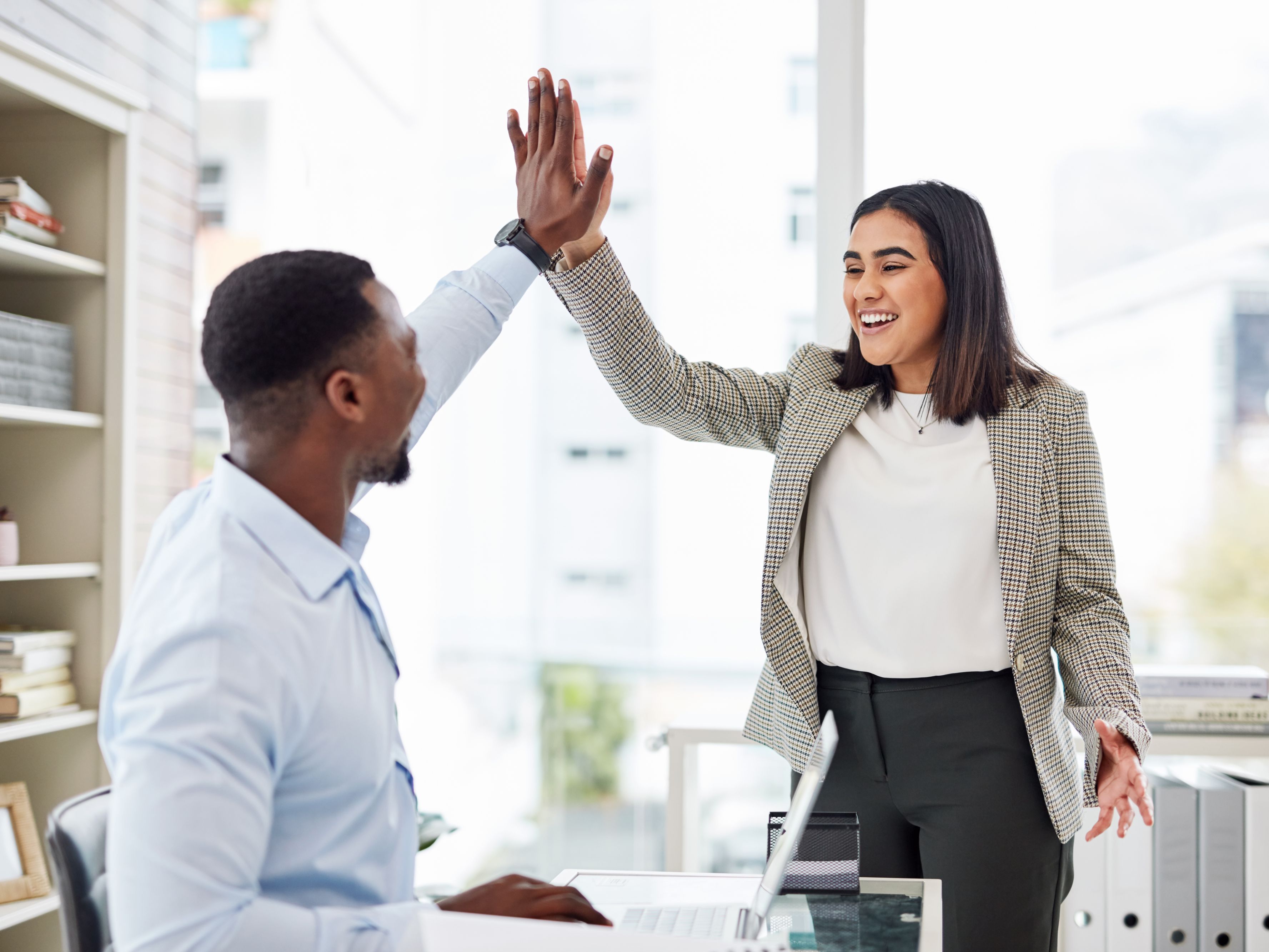 coworkers high fiving