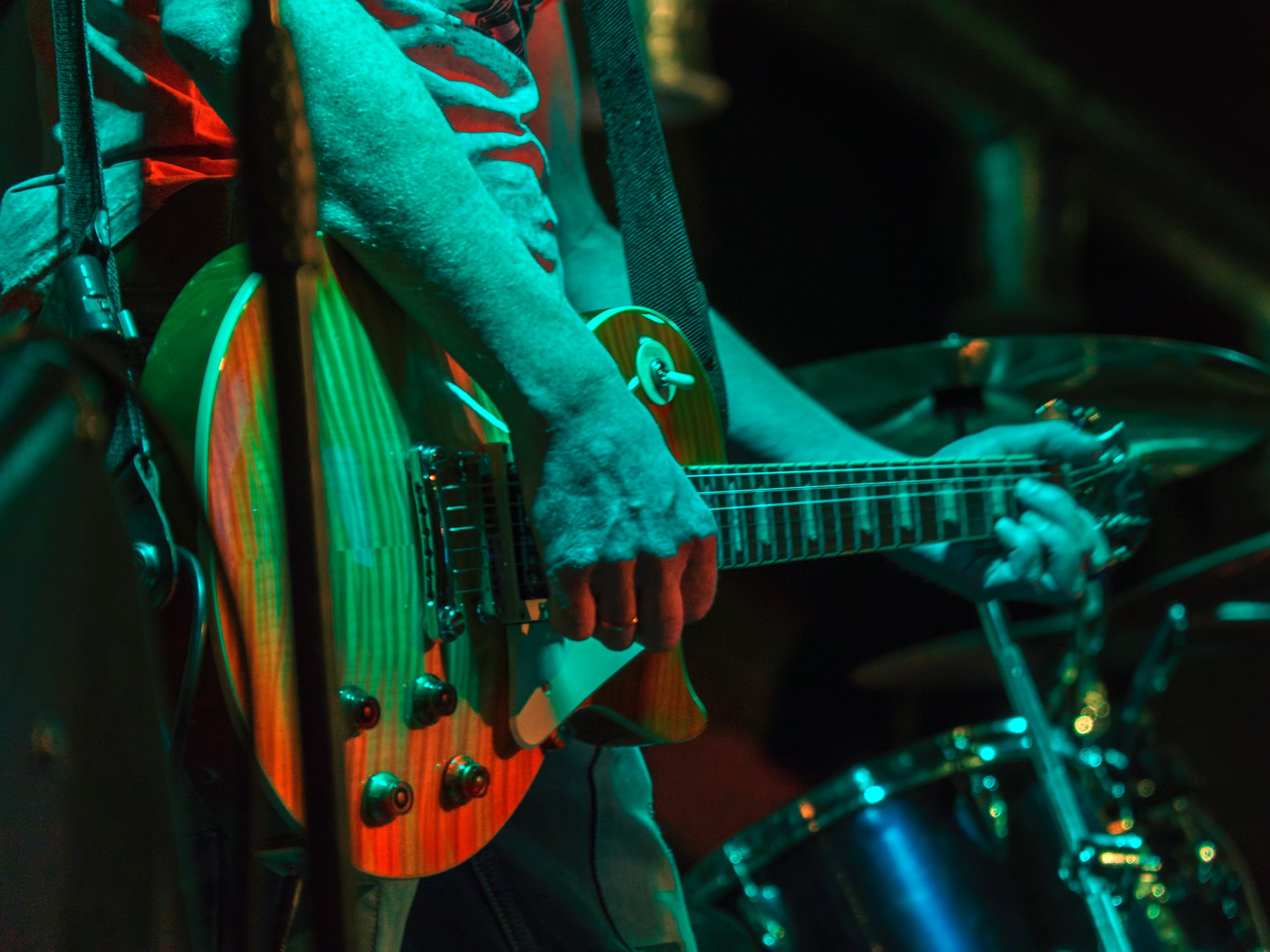 man playing guitar on a stage