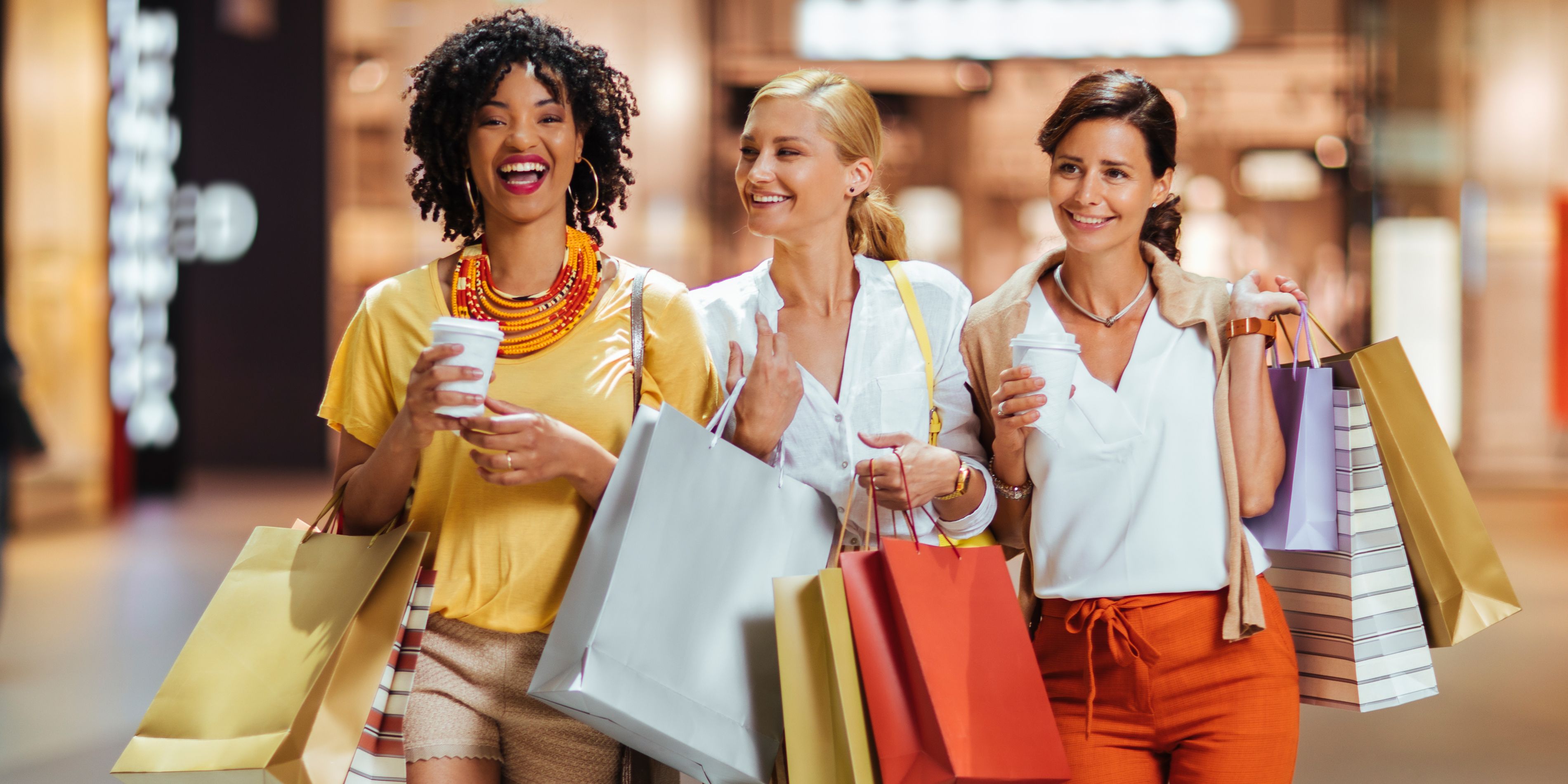 Three women walking with bags after shopping