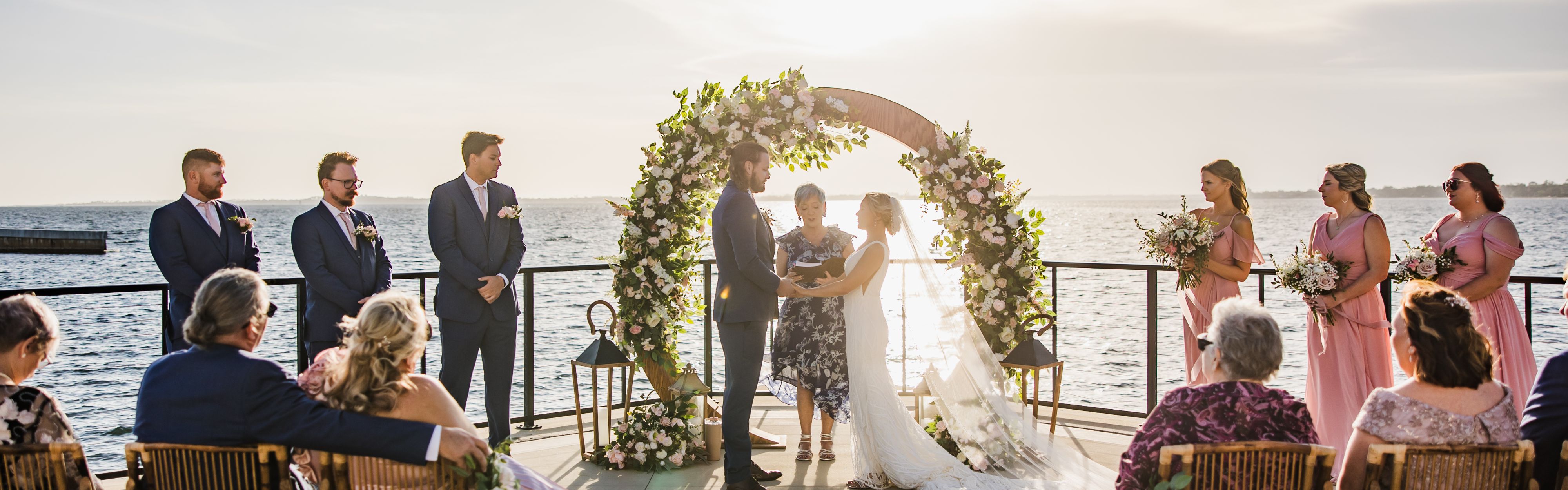 couple in front of wedding arch