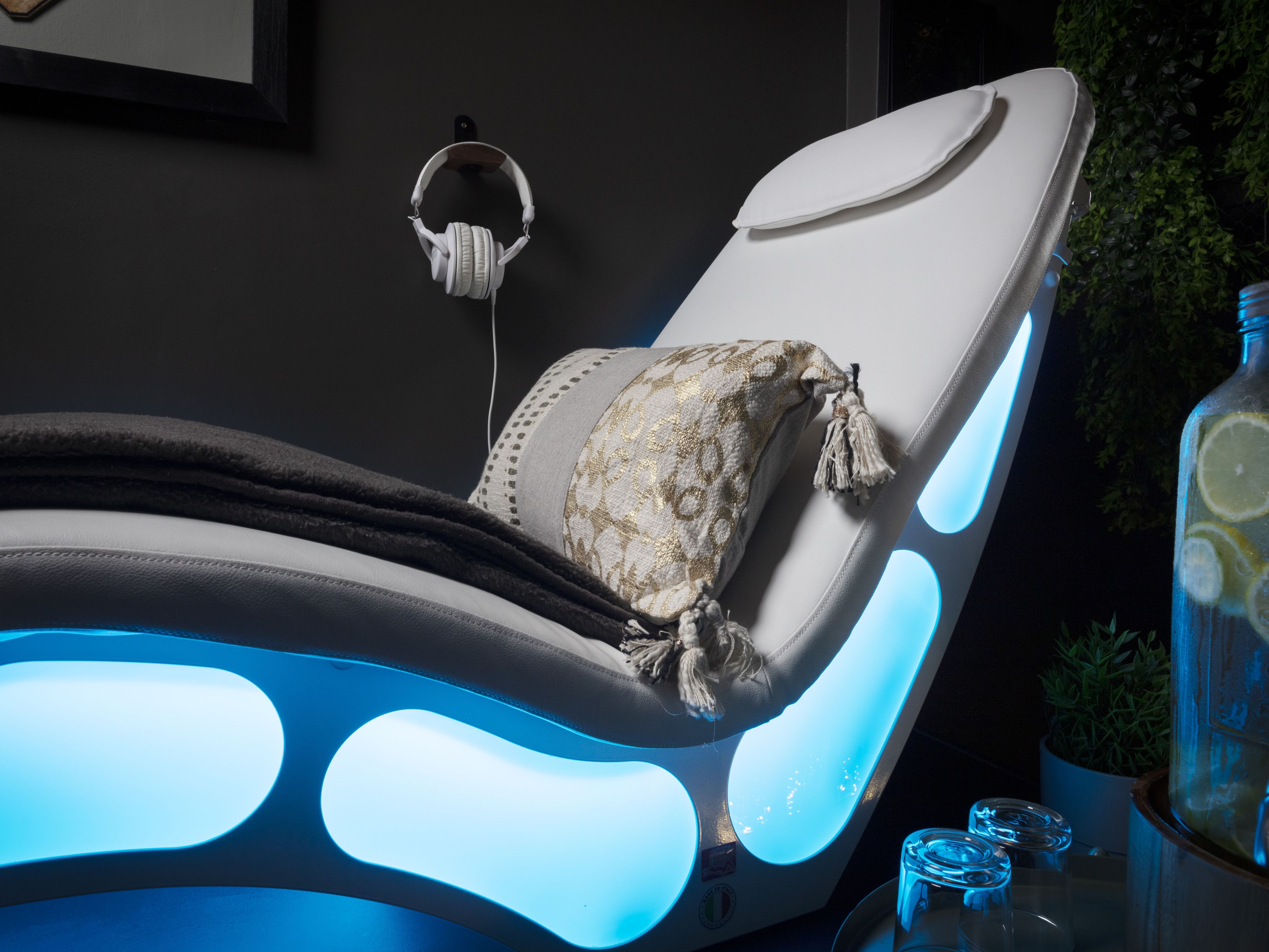 Comfy reclining chair with headphones on the wall