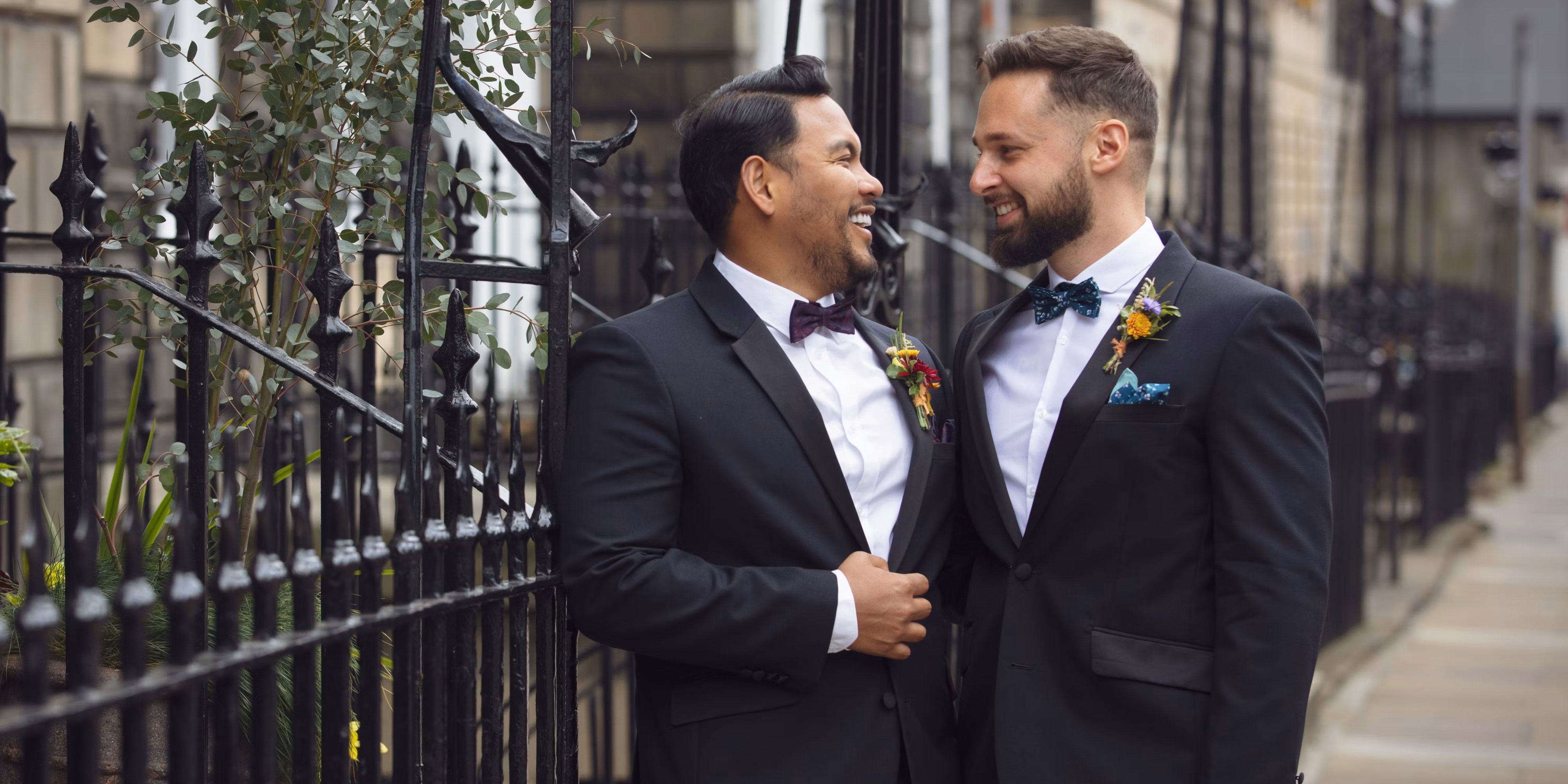 Grooms embracing on their wedding day