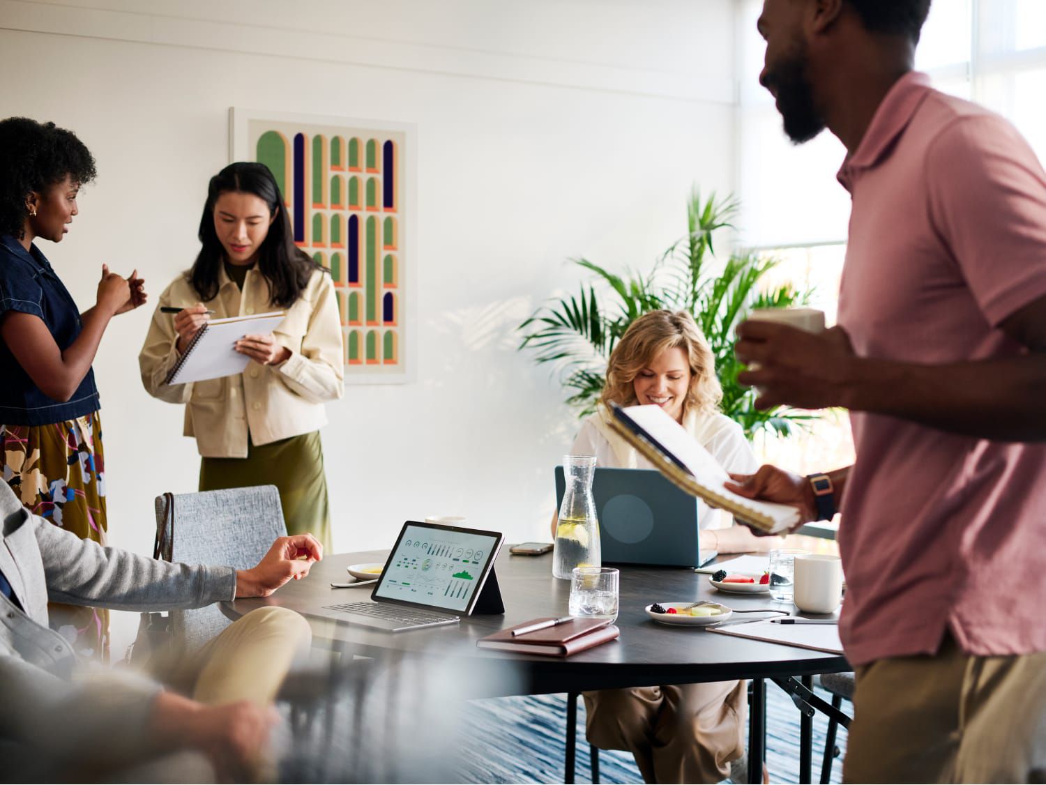 A group of colleagues collaborating in a modern meeting space.