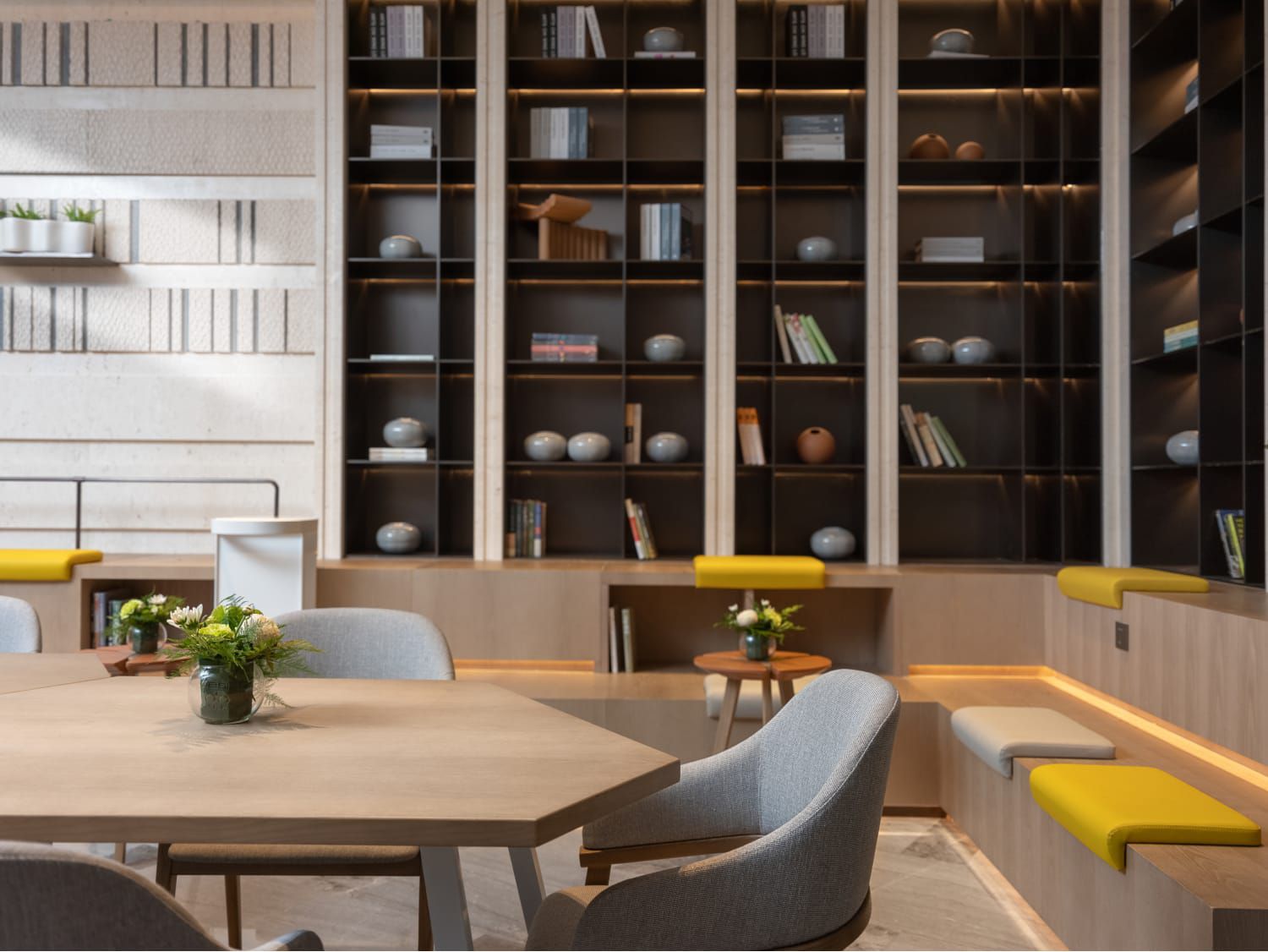 A gathering place lined with shelving, books, and seating options