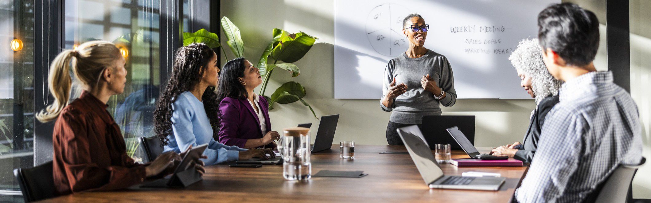 Trendy woman leading a business meeting
