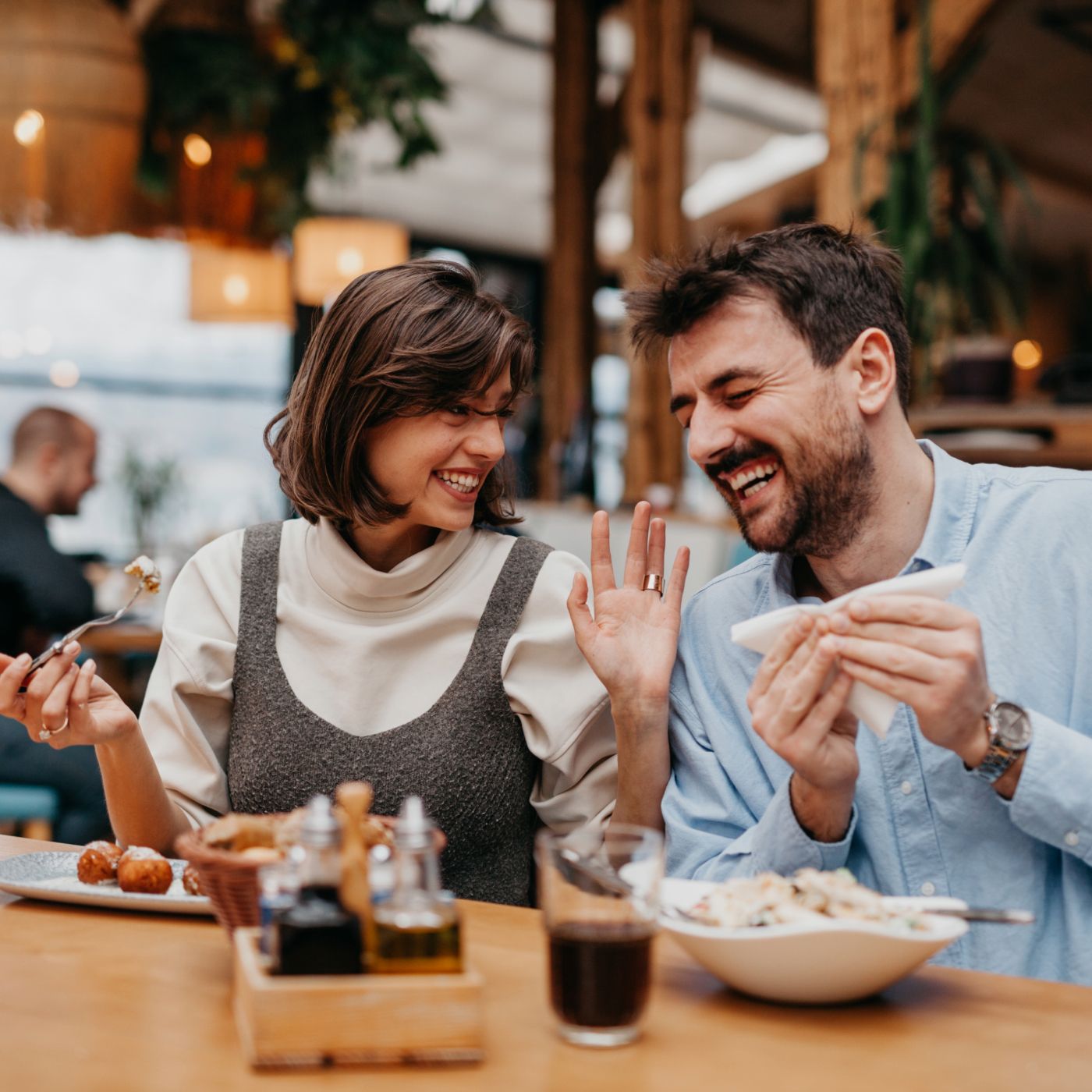 Man & woman enjoying lunch at restaurant table