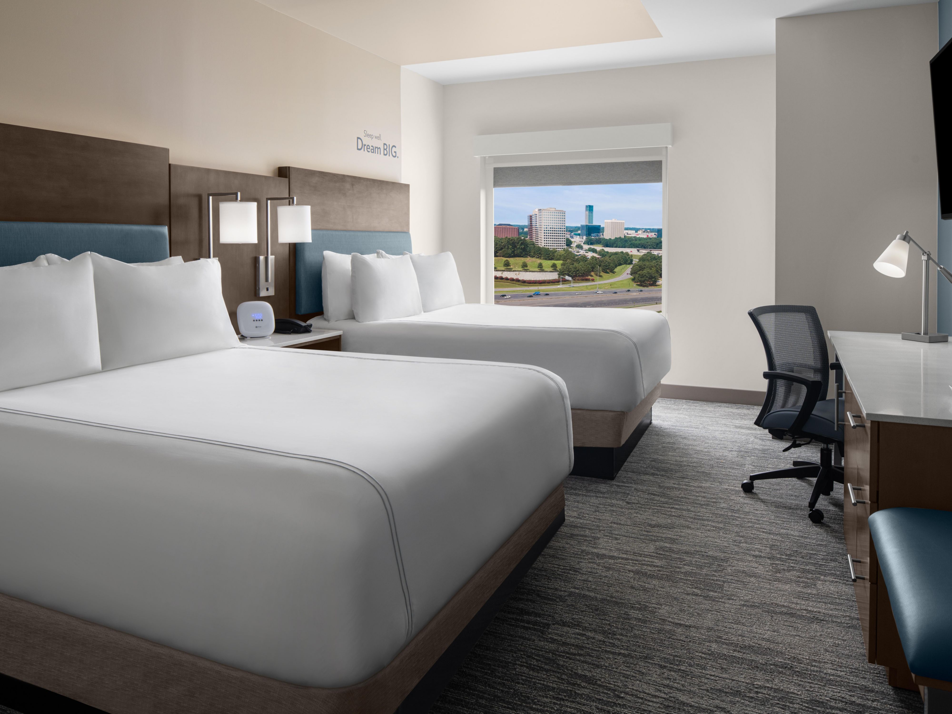 Two queen beds with a view of the city