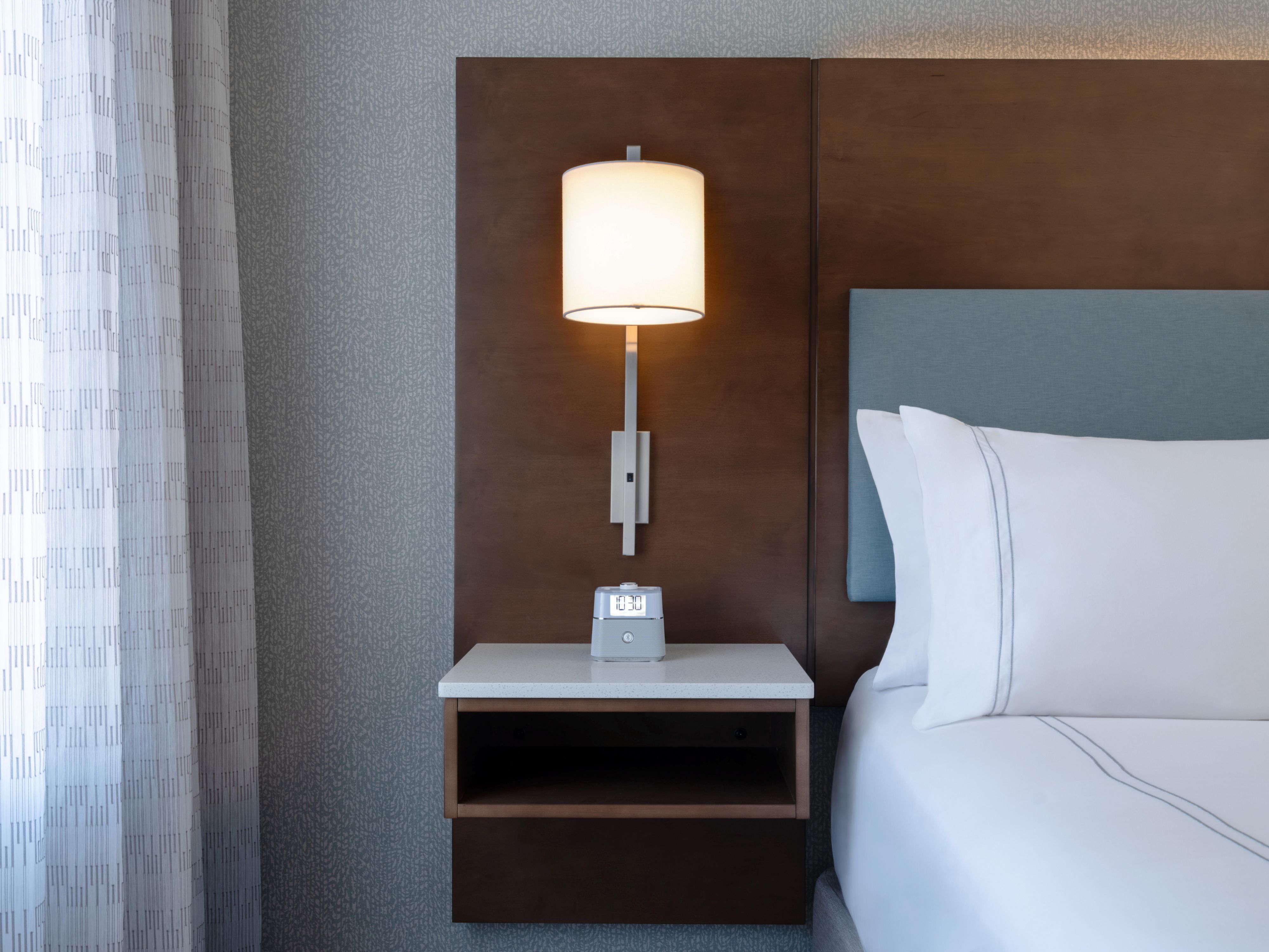 standard room with bedside lamp and clock
