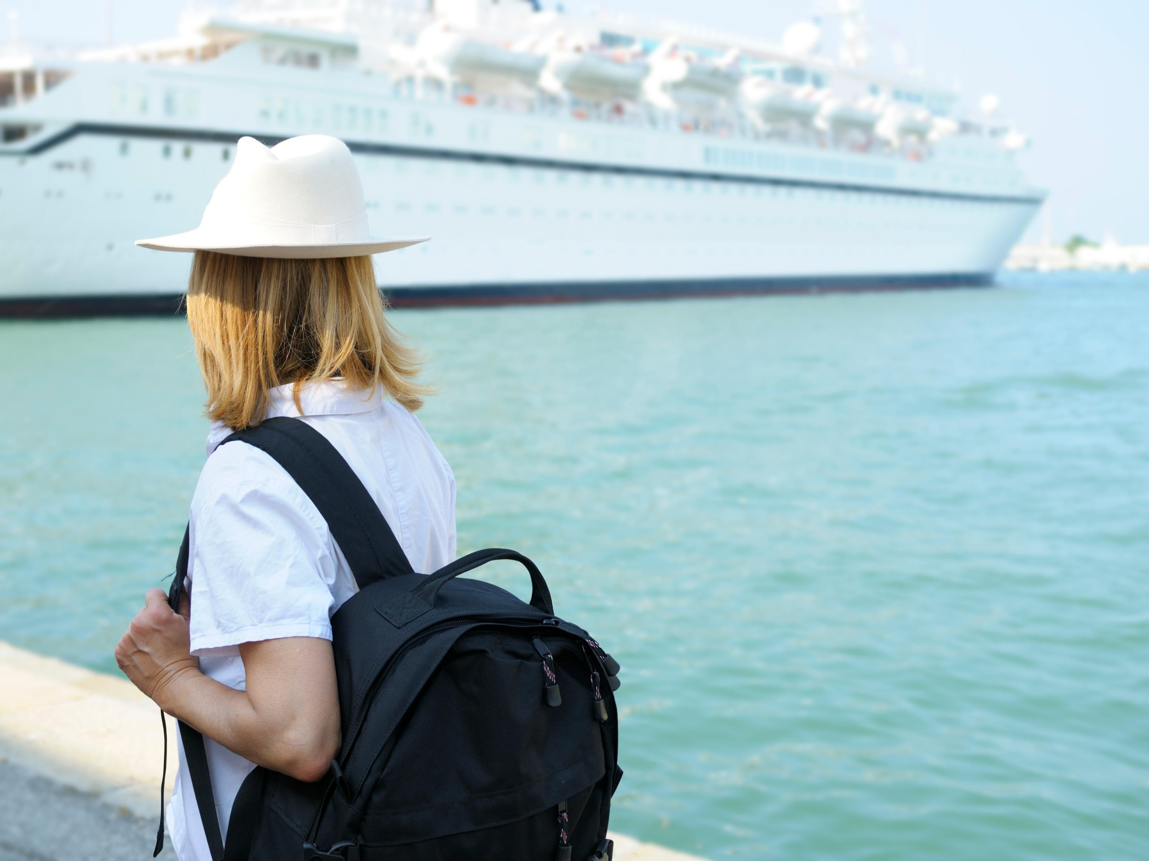 Guest walking towards a cruise ship in the ocean