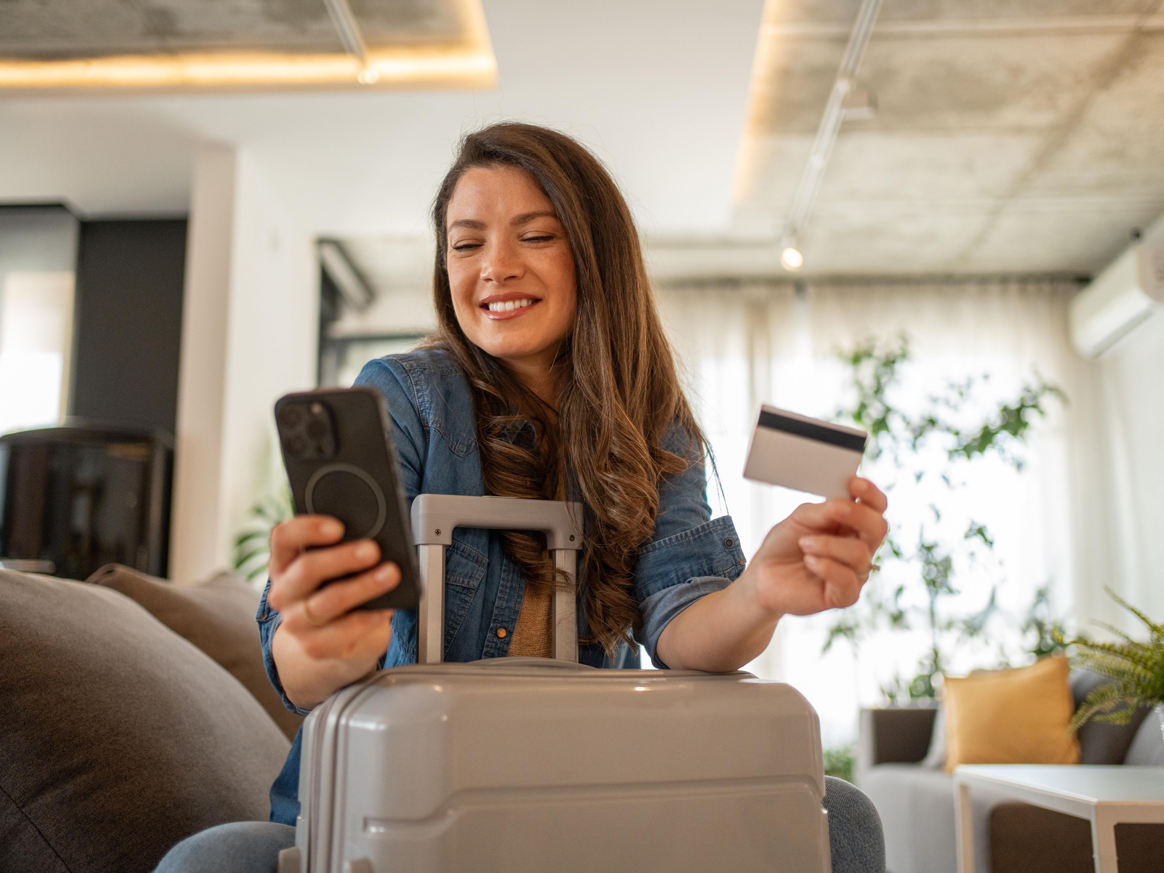 woman holding credit card in hotel lobby