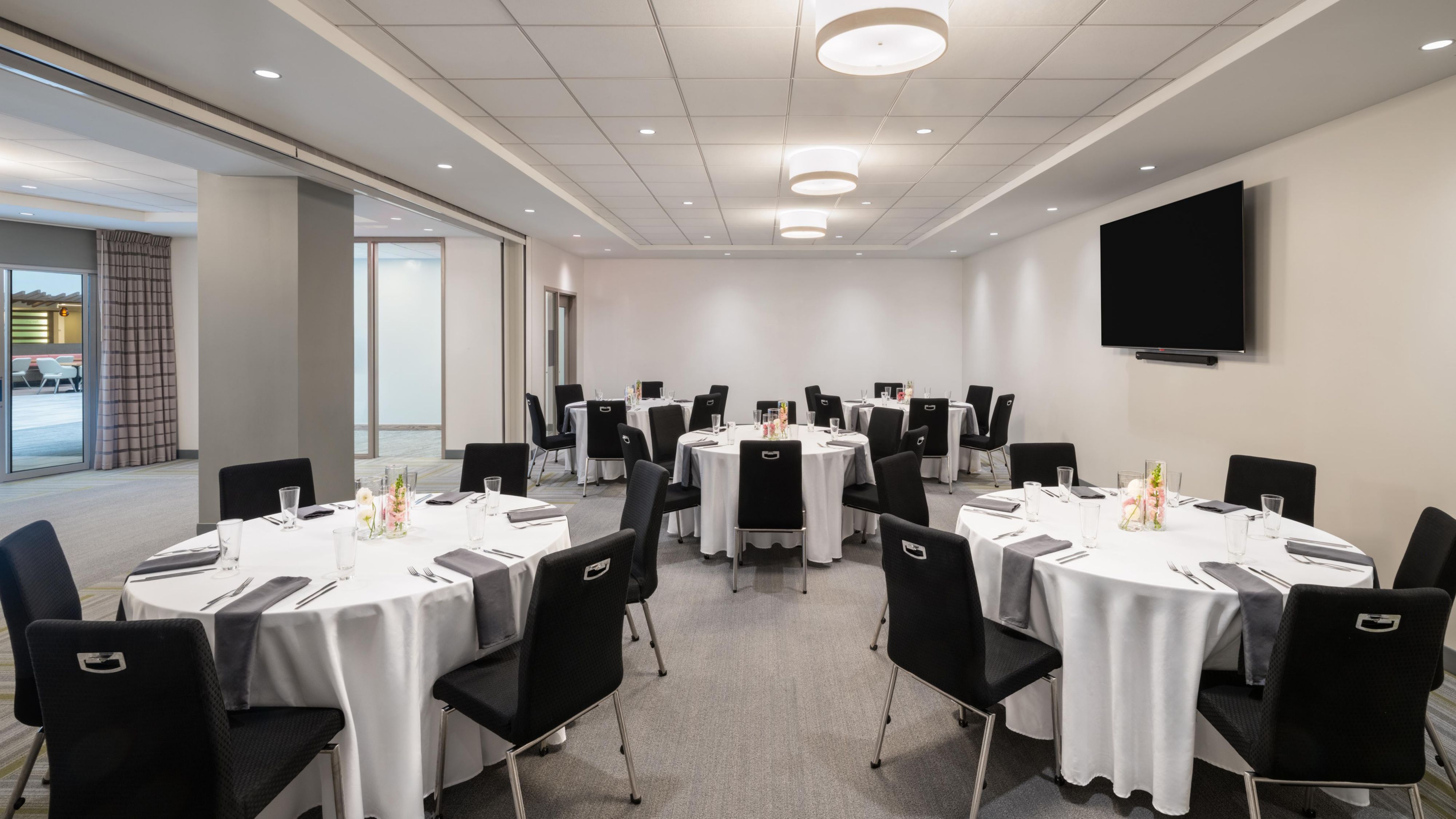 Open room with white cloth tables