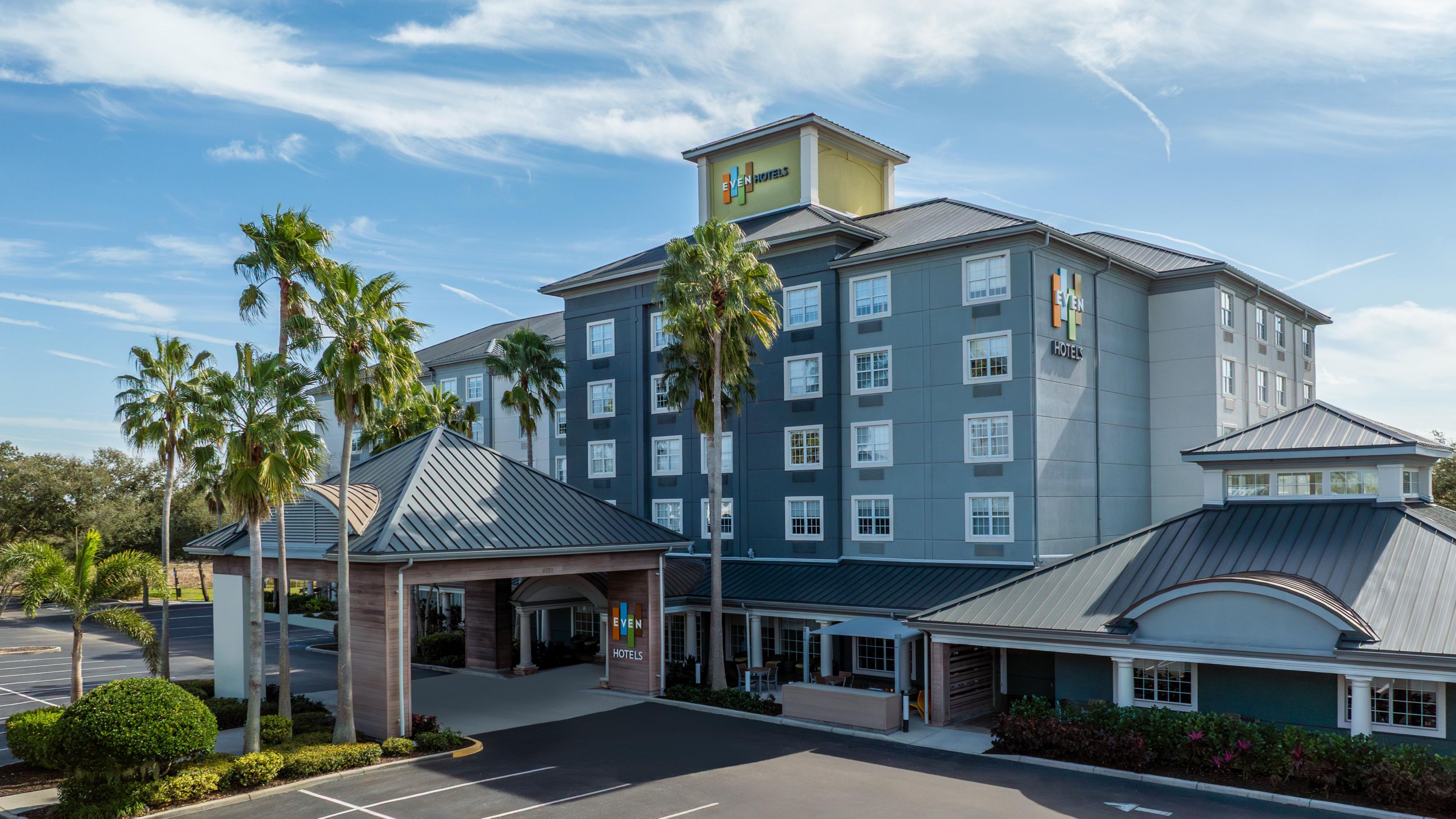 Exterior of the hotel with blue skies and plenty of trees