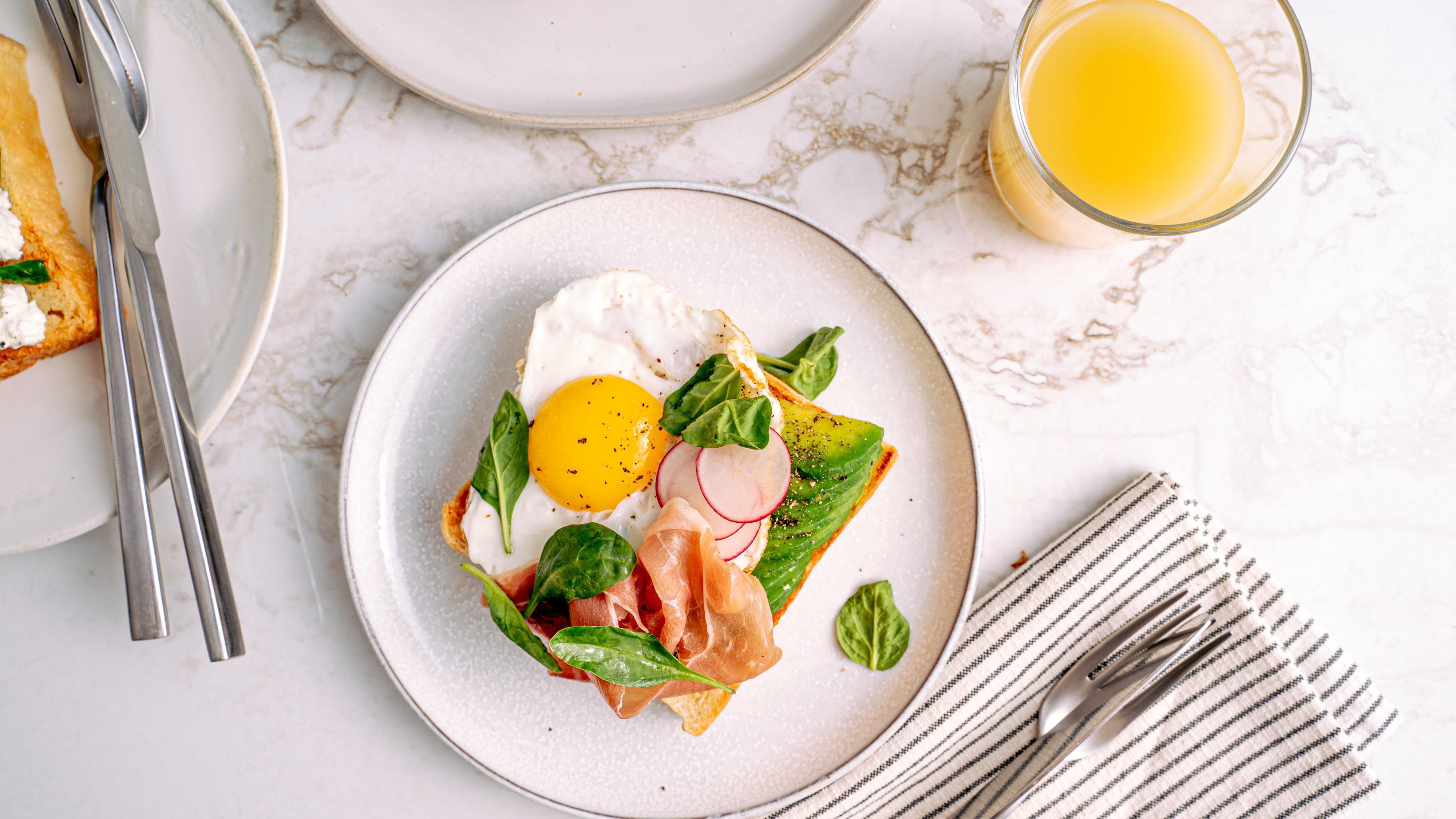 Avocado toast with prosciutto and an egg
