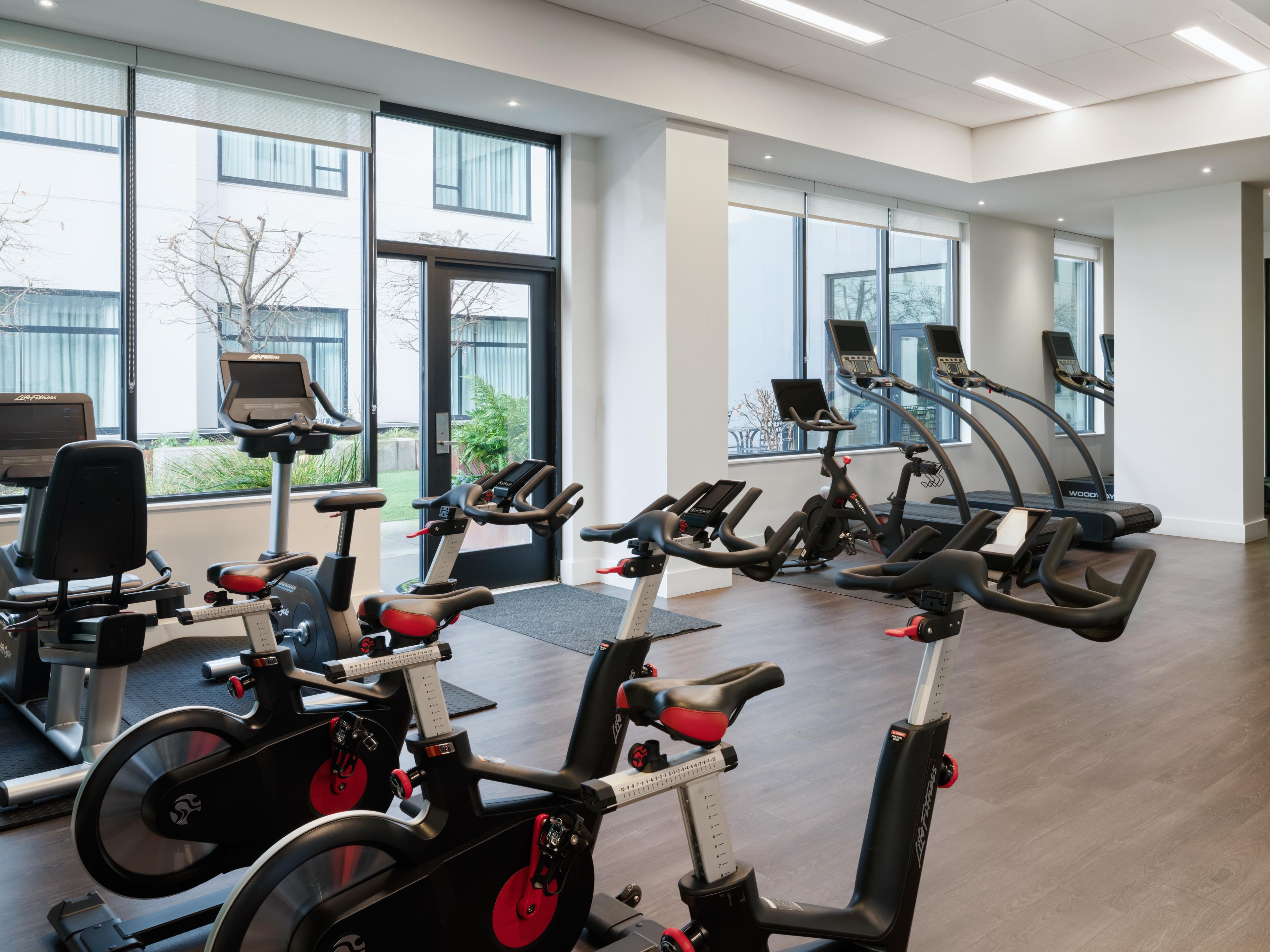 The athletic studio includes bikes, treadmills, and weights.